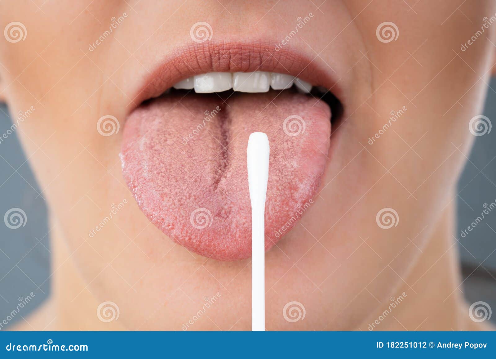 taking saliva test from woman`s mouth