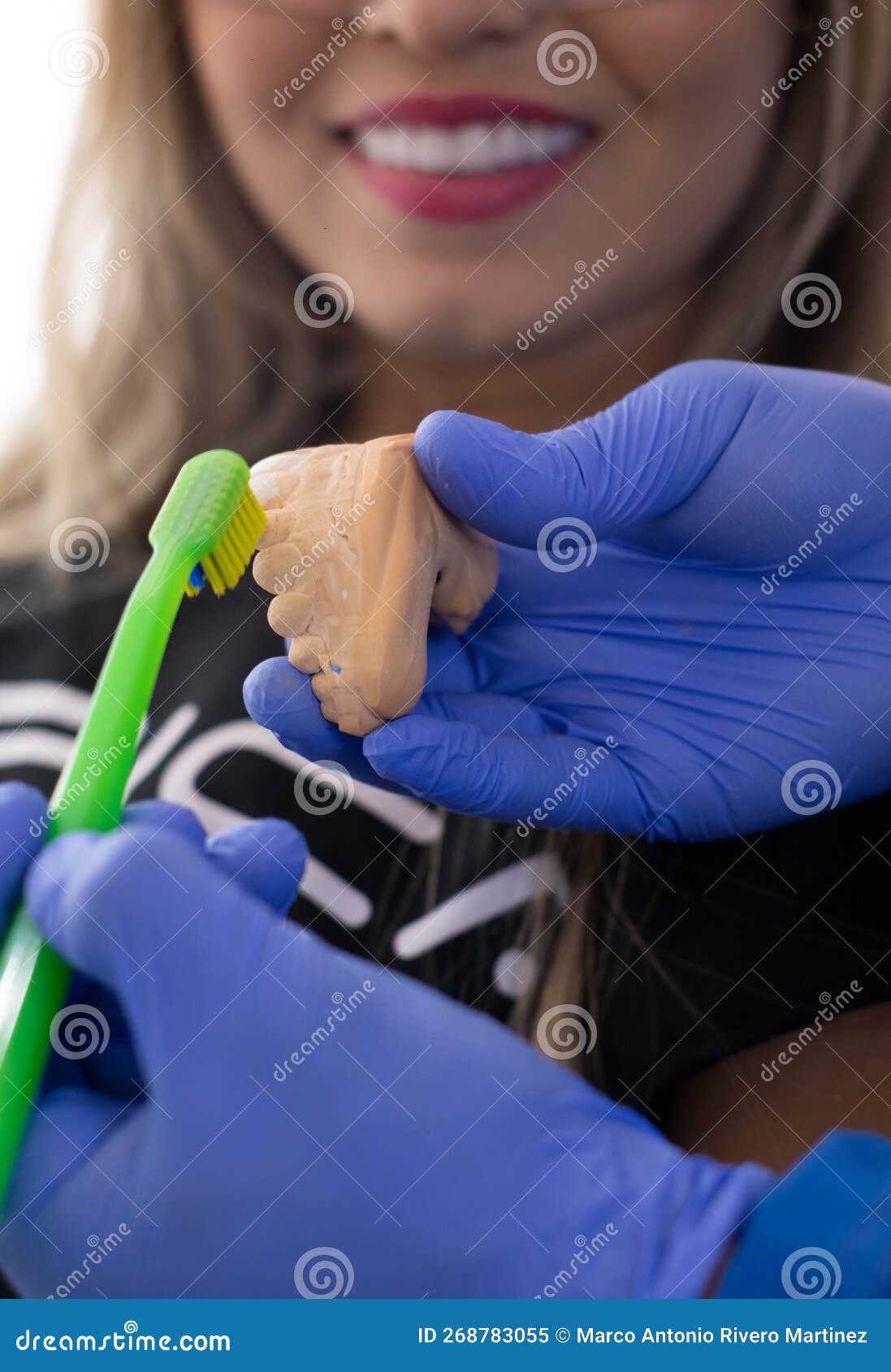 Dentist Teaching Child Boy How To Clean Teeth Using Toy Jaw Model