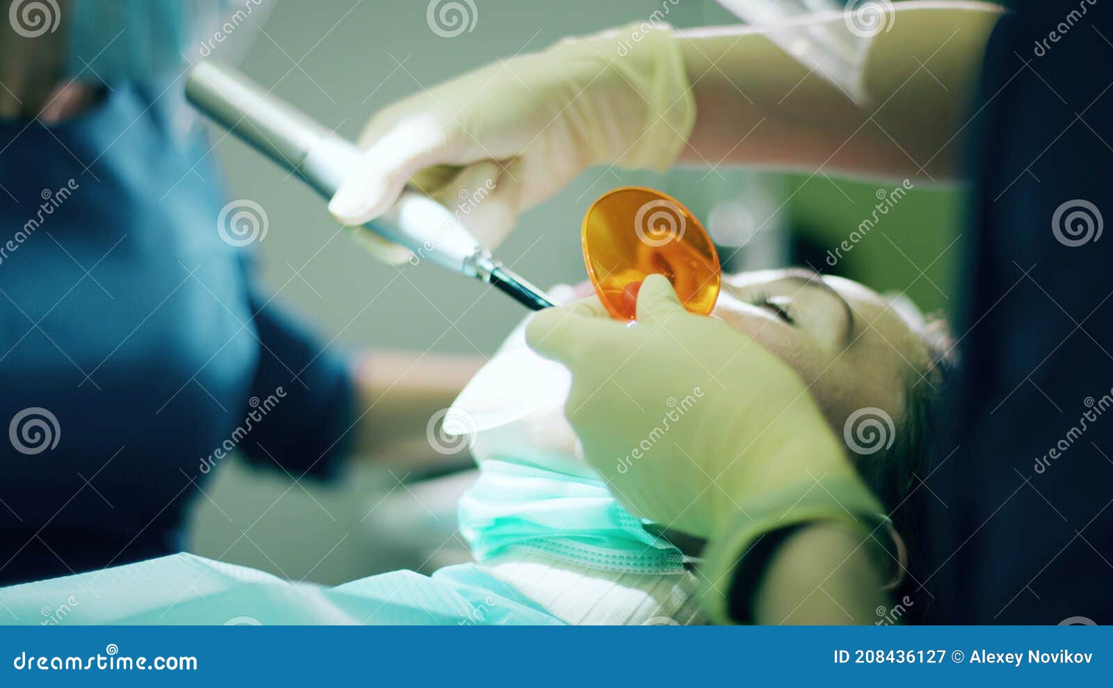 Dentist Uses the Dental Curing Light Stock Image Image of female, medical 208436127