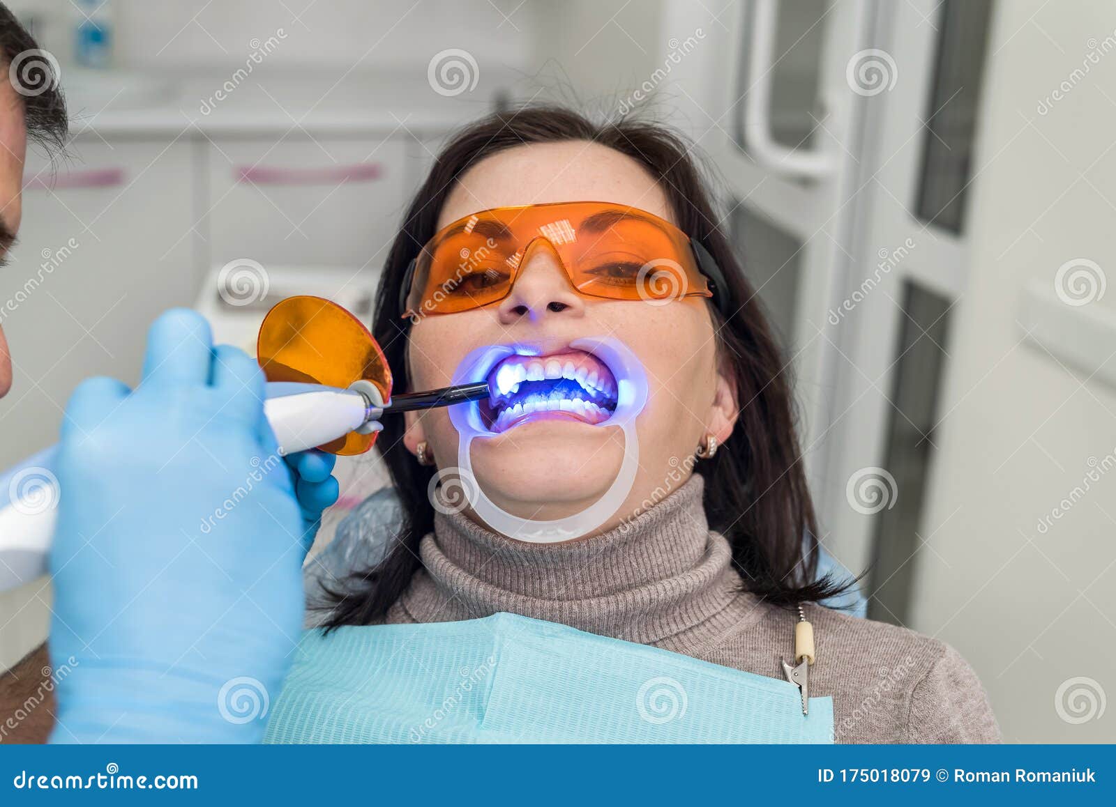 Dentist Using Uv Lamp while Treating Patient`s Teeth Stock Image