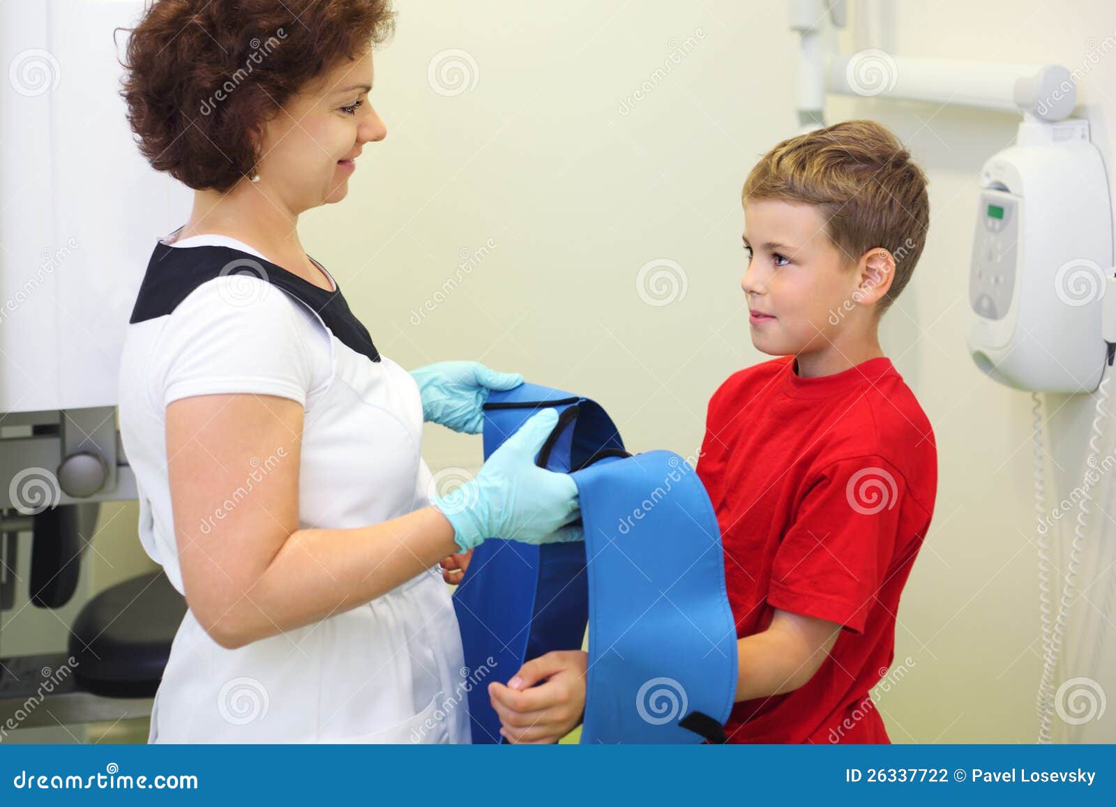 dentist wears protective lead apron to boy