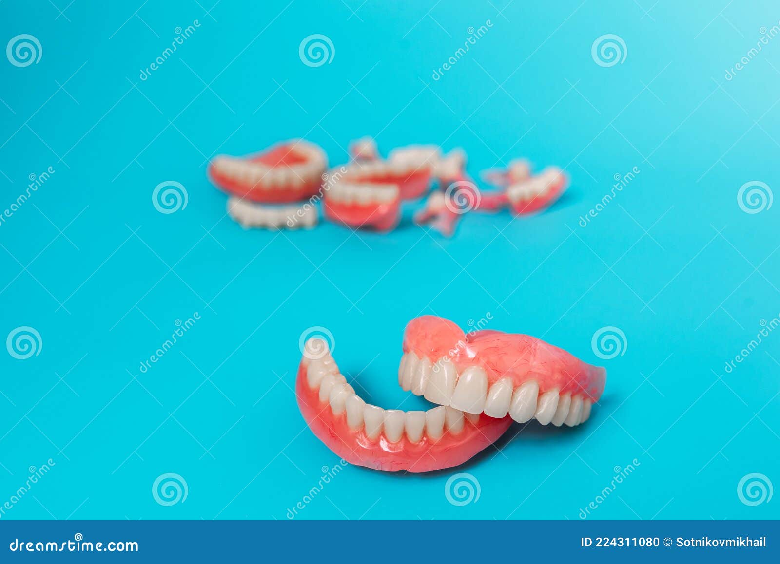 Dentures on a Blue Background. Closeup of Dentures. Full Removable