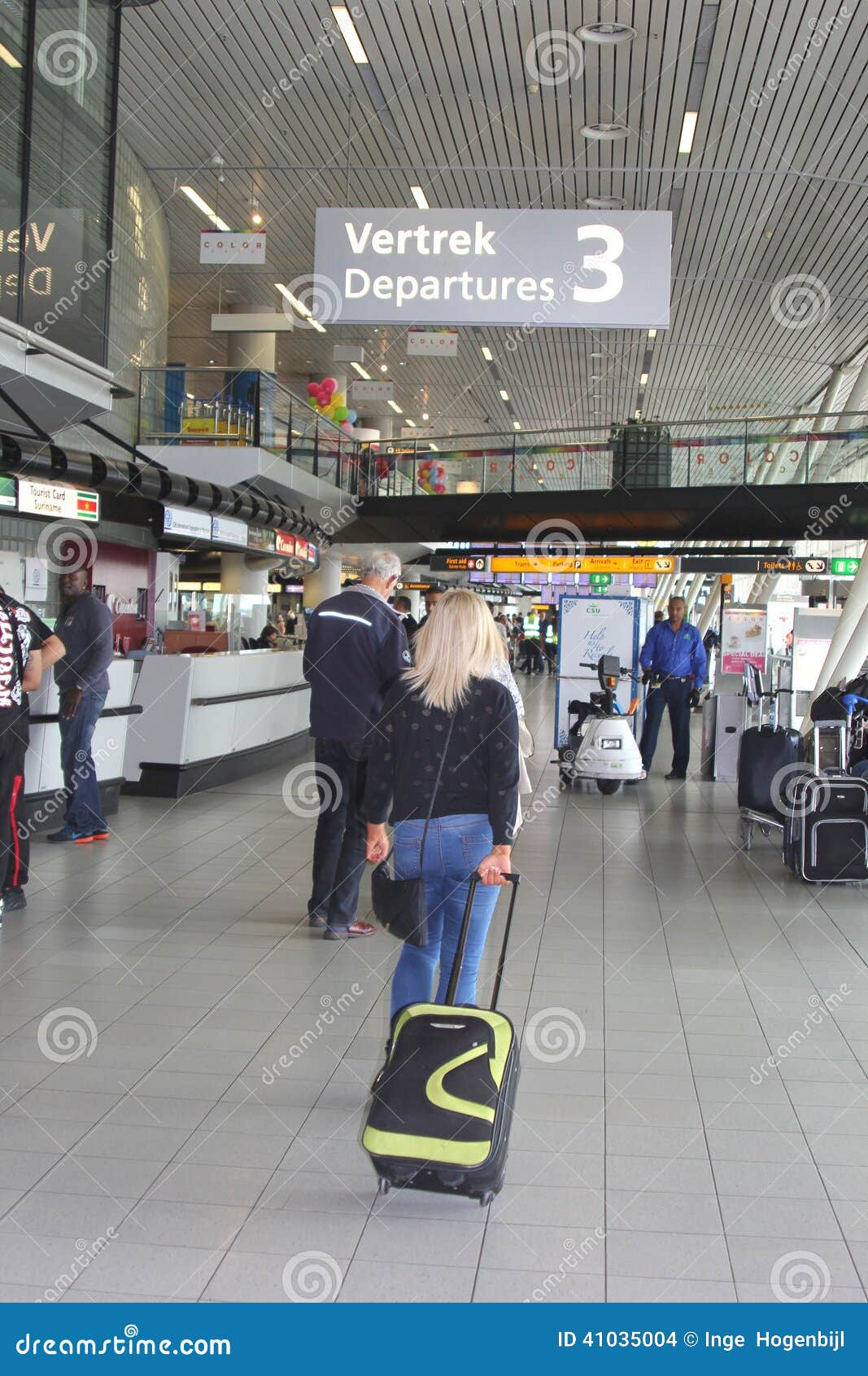 Departing Passengers And Information Desk At Amsterdam Schiphol