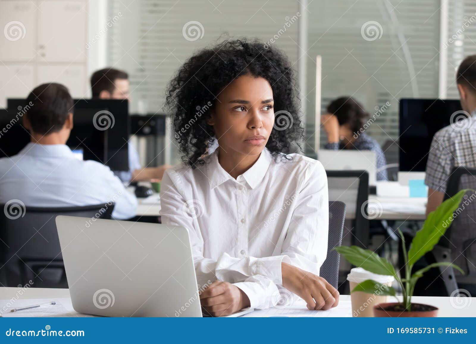 depressed black woman distracted from work lost in thoughts