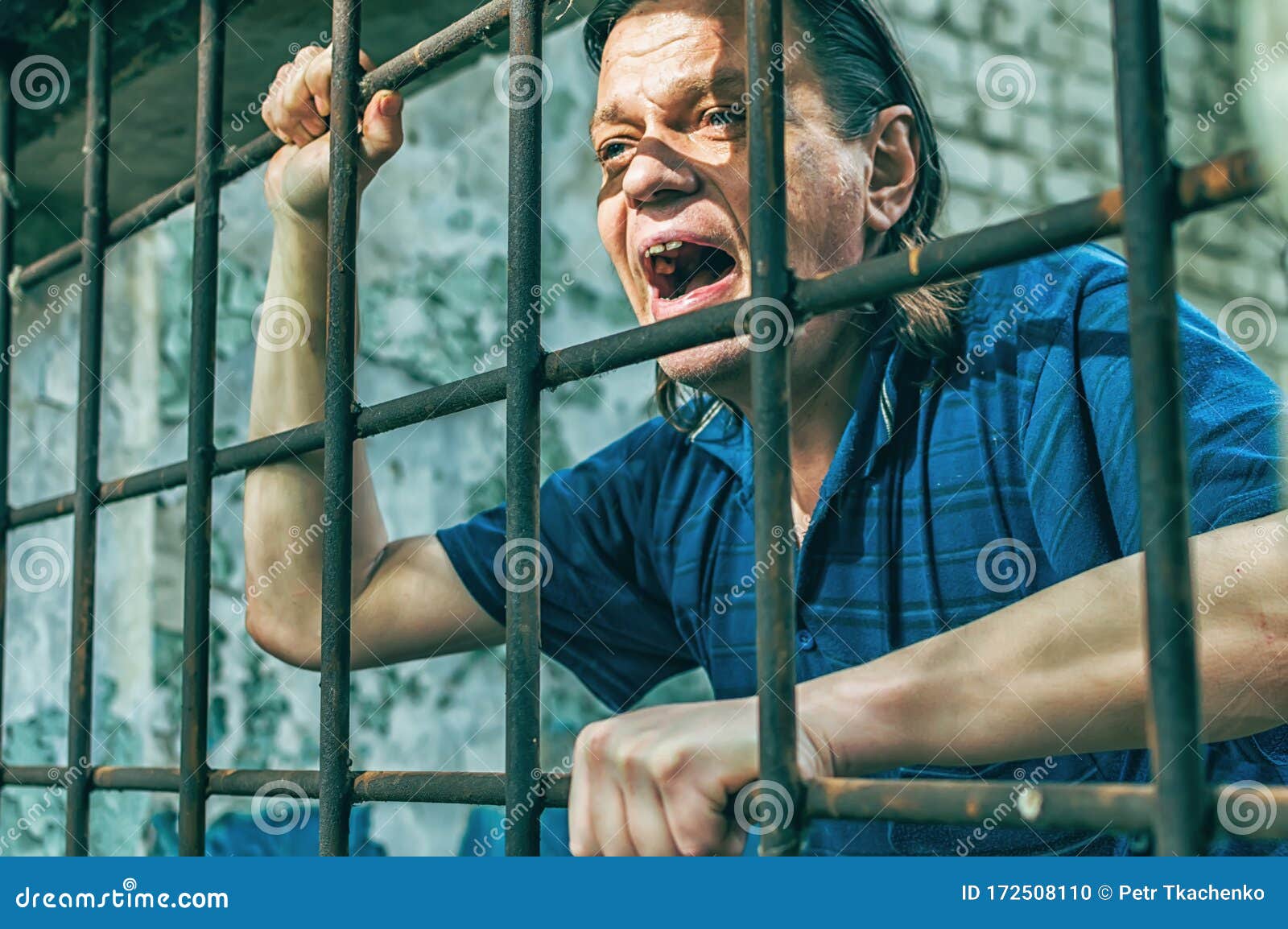 A Depressed Man In Handcuffs Behind Bars A Depressed Arrested Male Offender Is Jailed Shouts 
