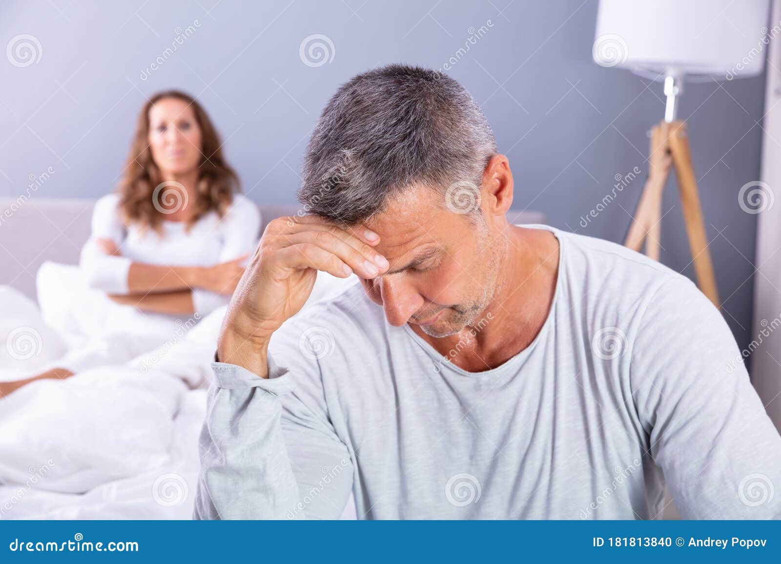 depressed man sitting on bed