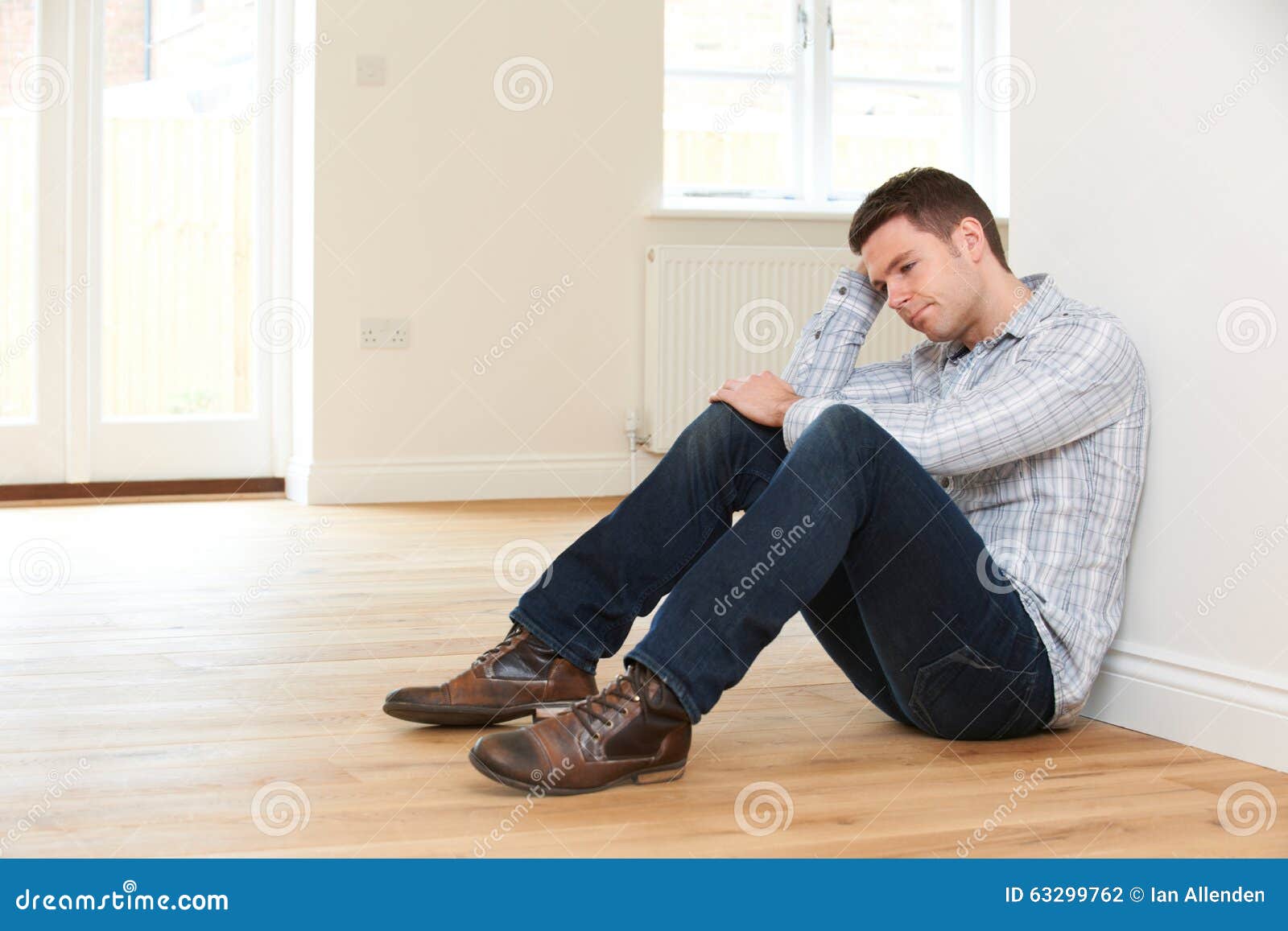 Depressed Man Sitting in Empty Room of Repossessed House Stock Photo ...
