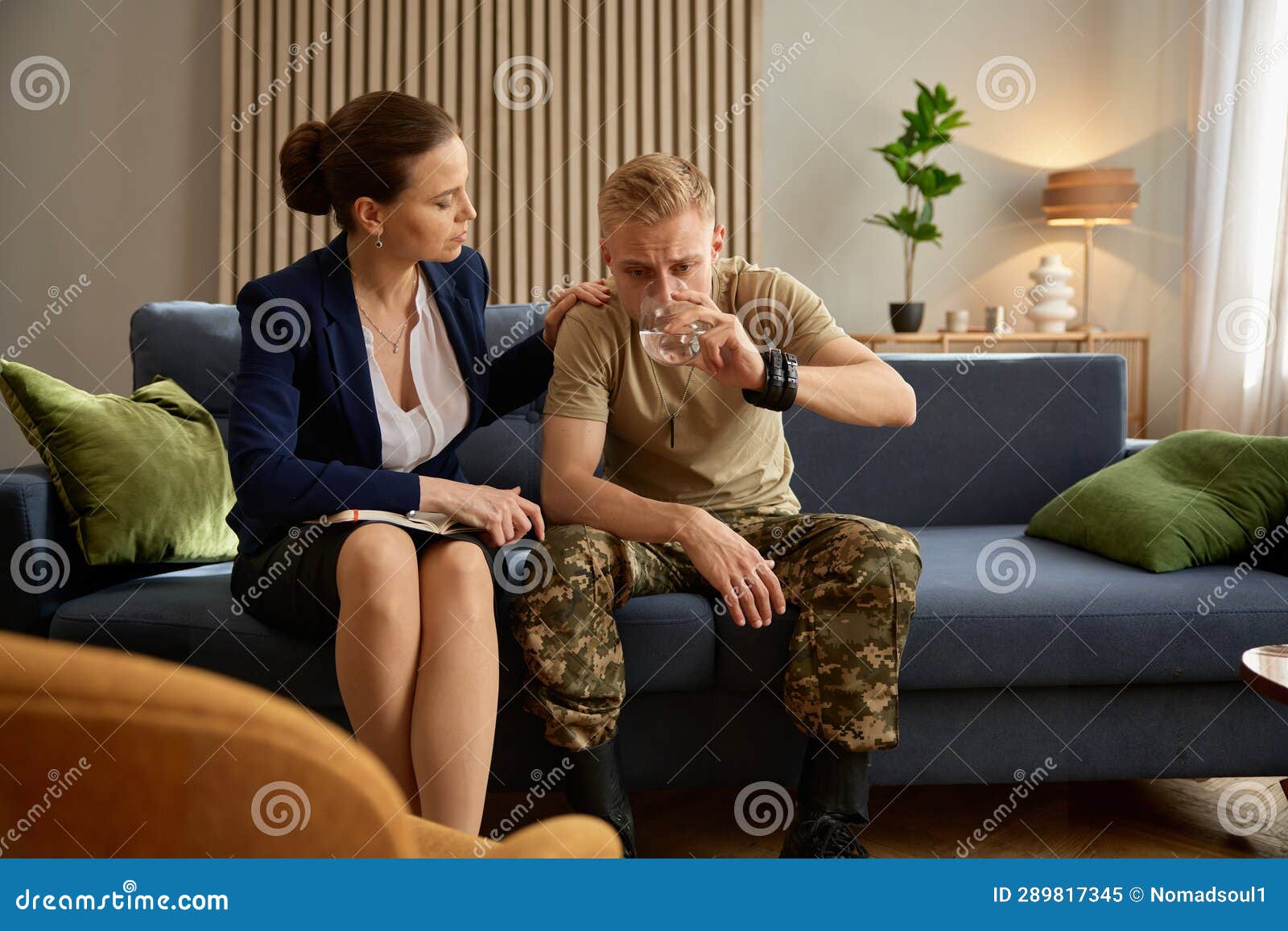 depressed soldier drinking water at psychotherapeutic session