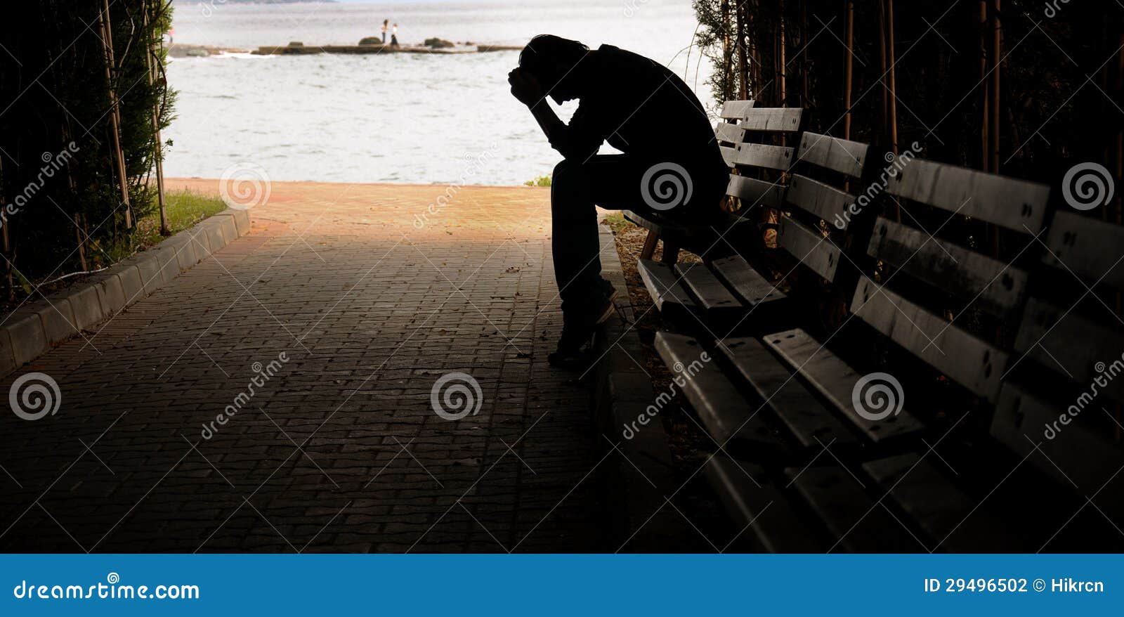 depressed young man sitting on the bench