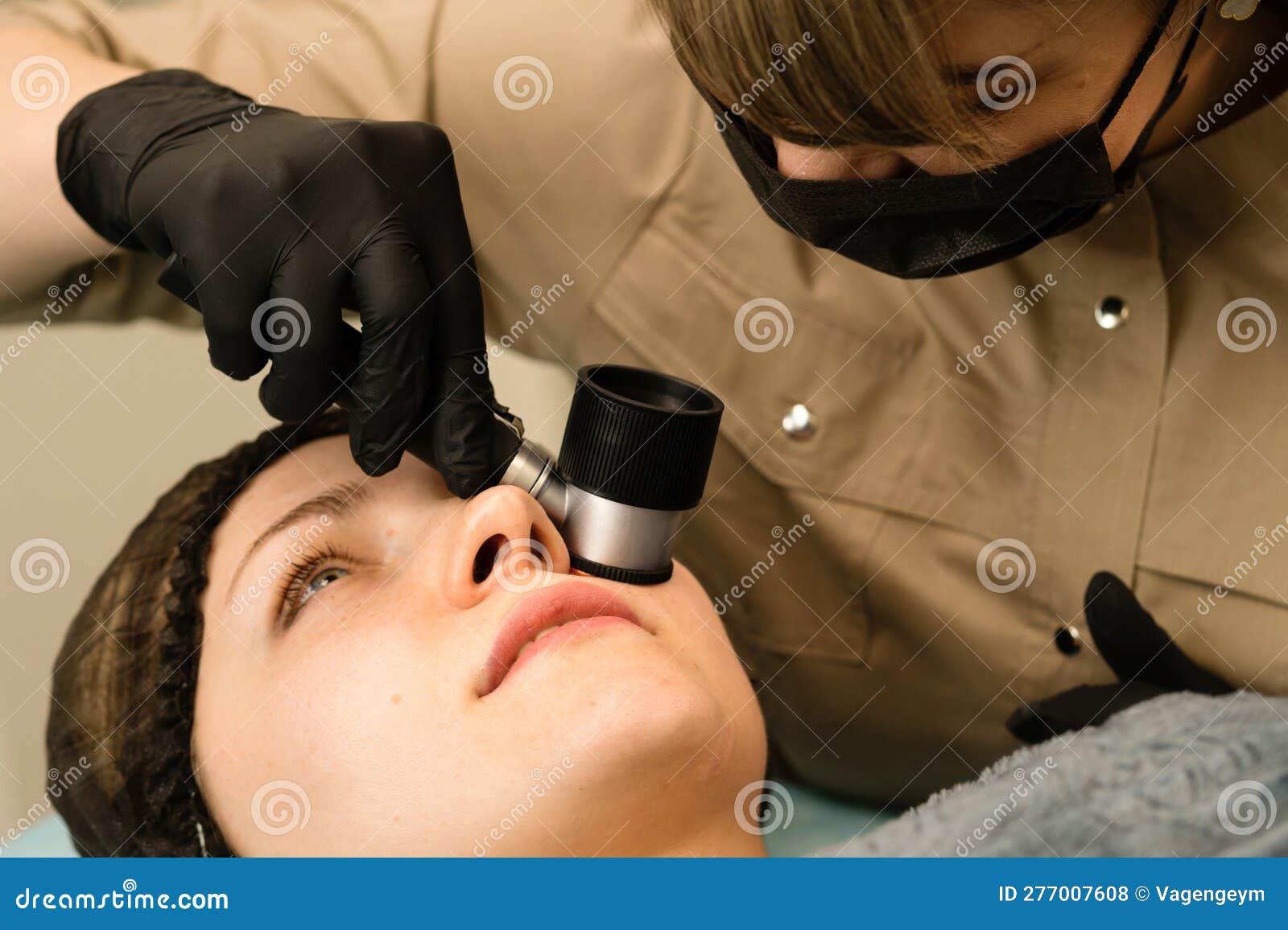 Dermatologist Examines Moles With Dermatoscope Royalty Free Stock Image Dermatologist Examines Moles With Dermatoscope Royalty Free Stock Image