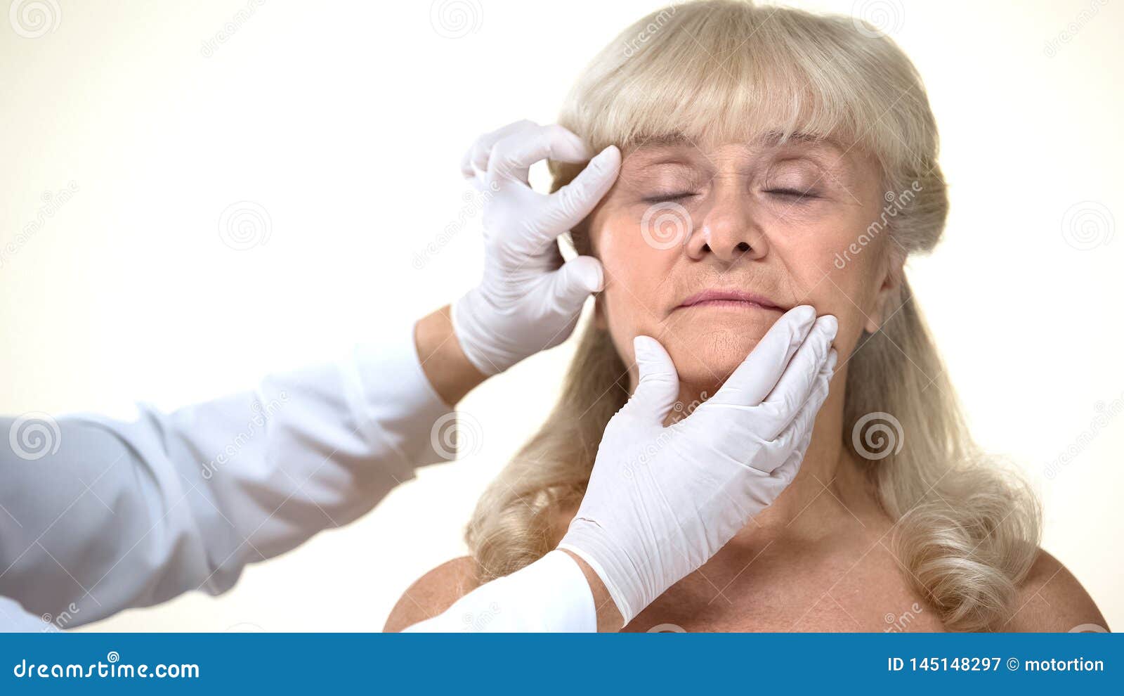 Dermatologist examining elderly female patient skin, wrinkles removal, beauty, stock photo