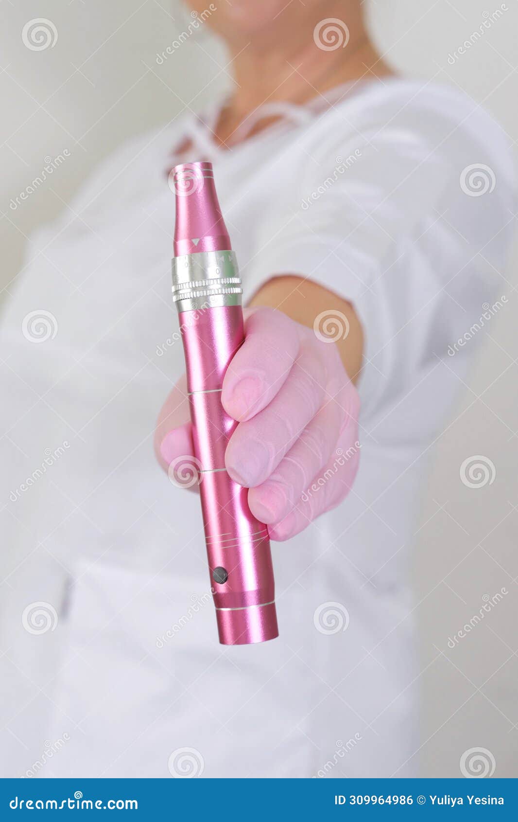 dermatologist holding a pink dermapen