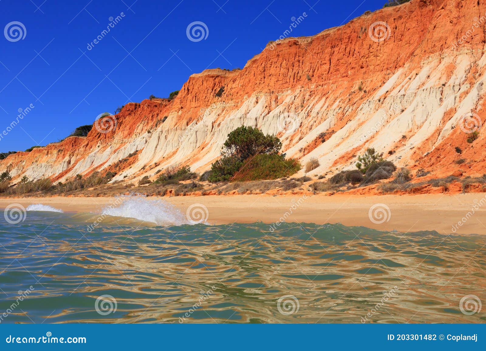 deserted golden sandy beach in olhos de agua, albufeira, algarve, portugal.