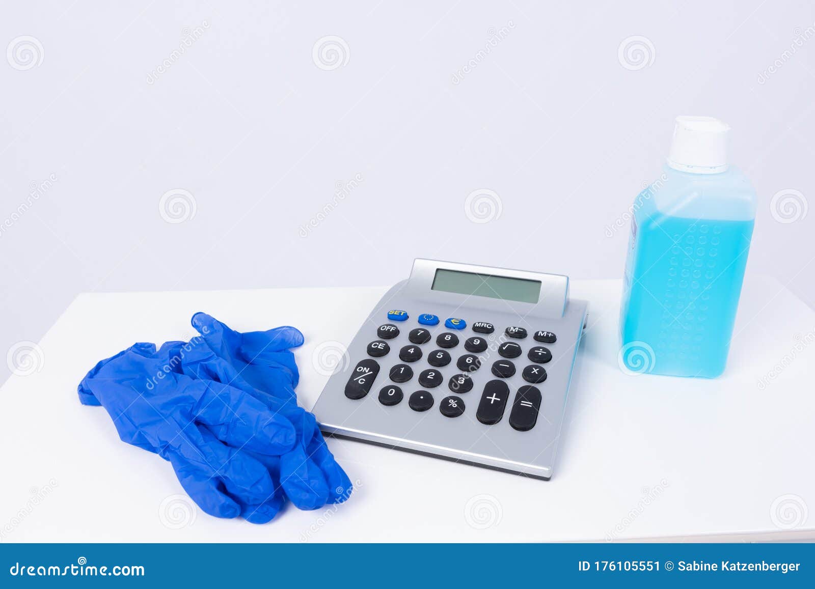 desinfecting material and a calculator on a white surface