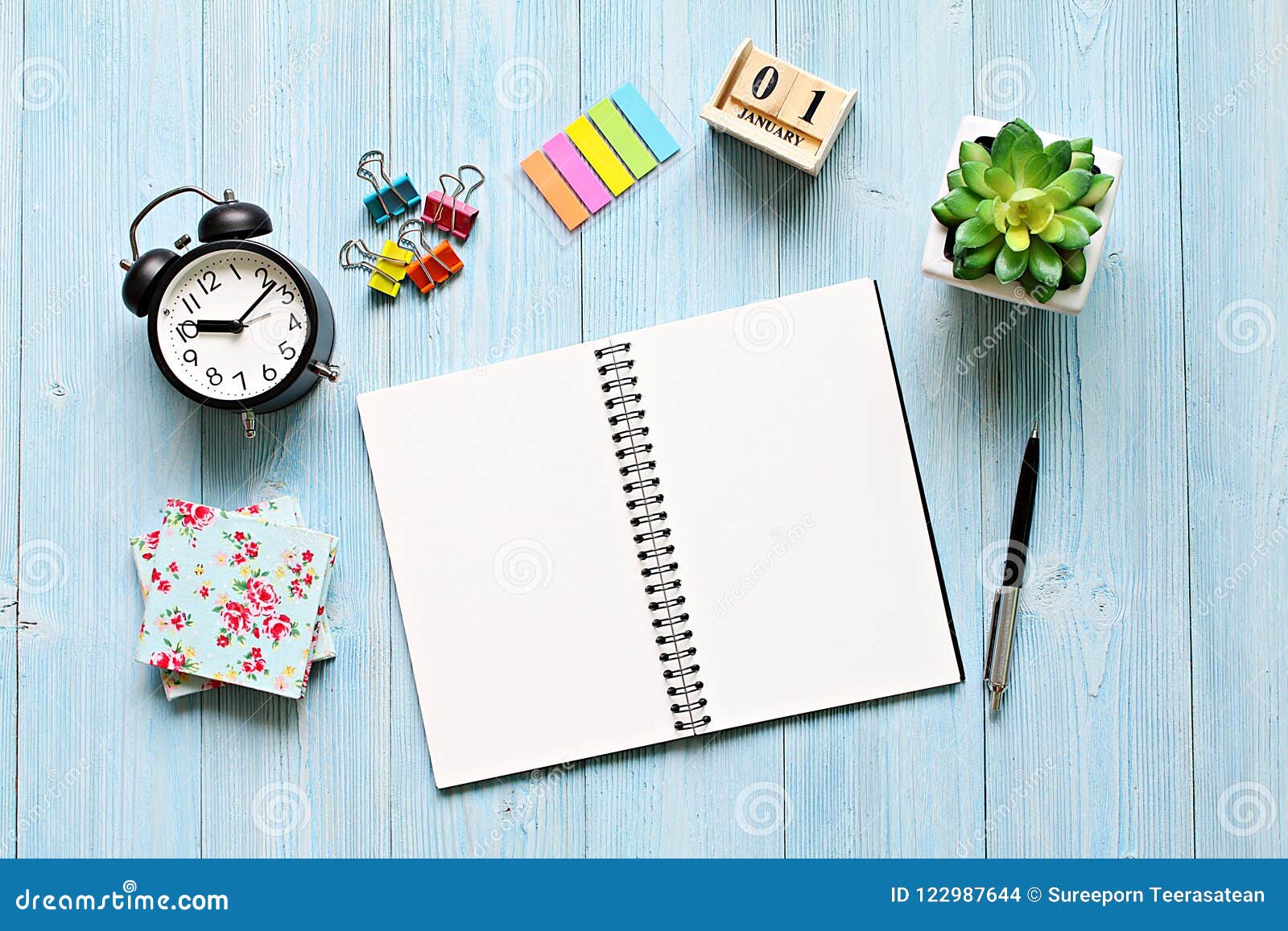 Desk Table With Open Notebook Paper Cube Calendar And Clock Stock