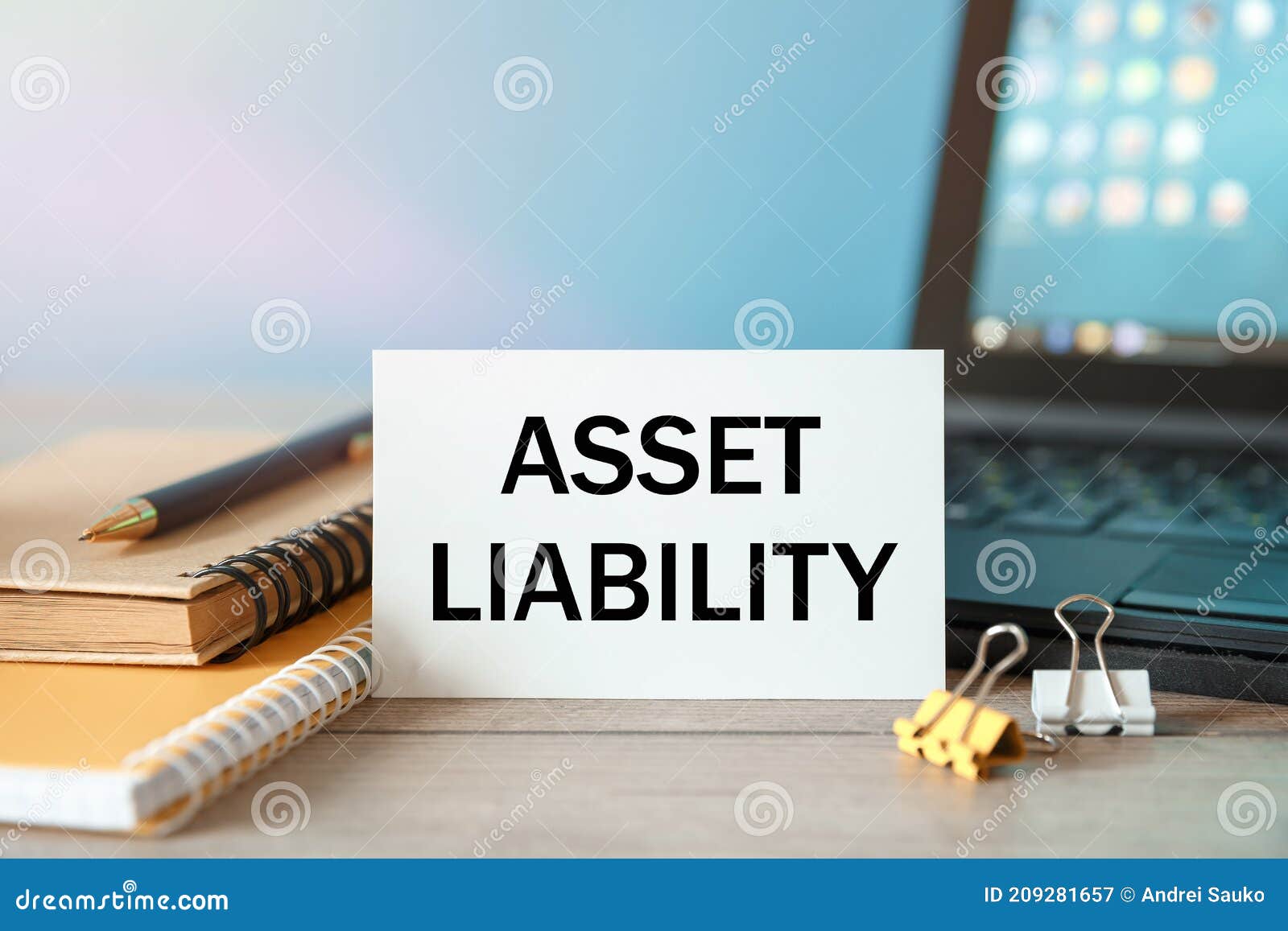 desktop with documents, calculator and notebook. inscription asset liability