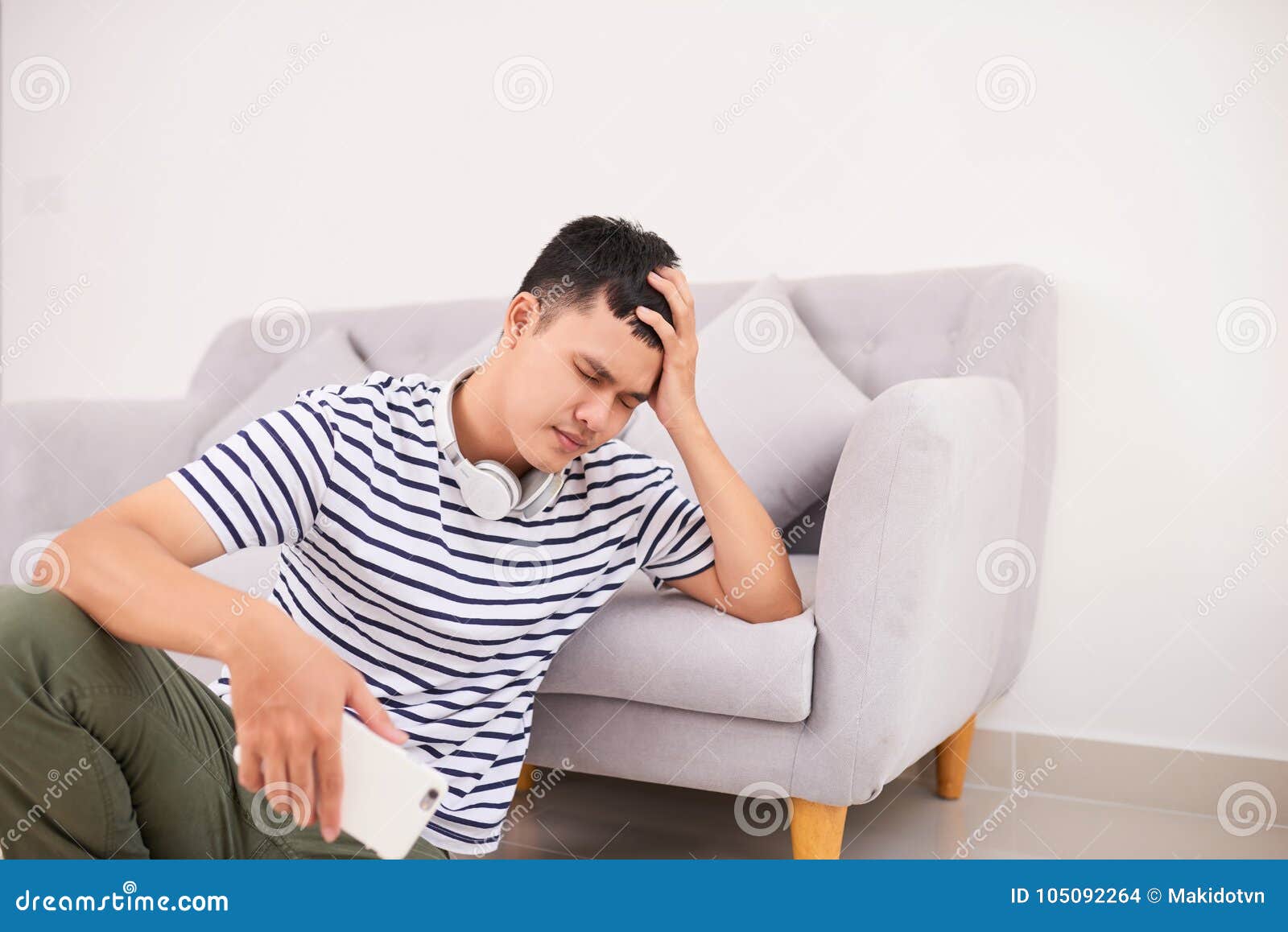 Despaired Young Man Sitting On Floor Holding Smartphone Stock Photo Image Of Sitting Young