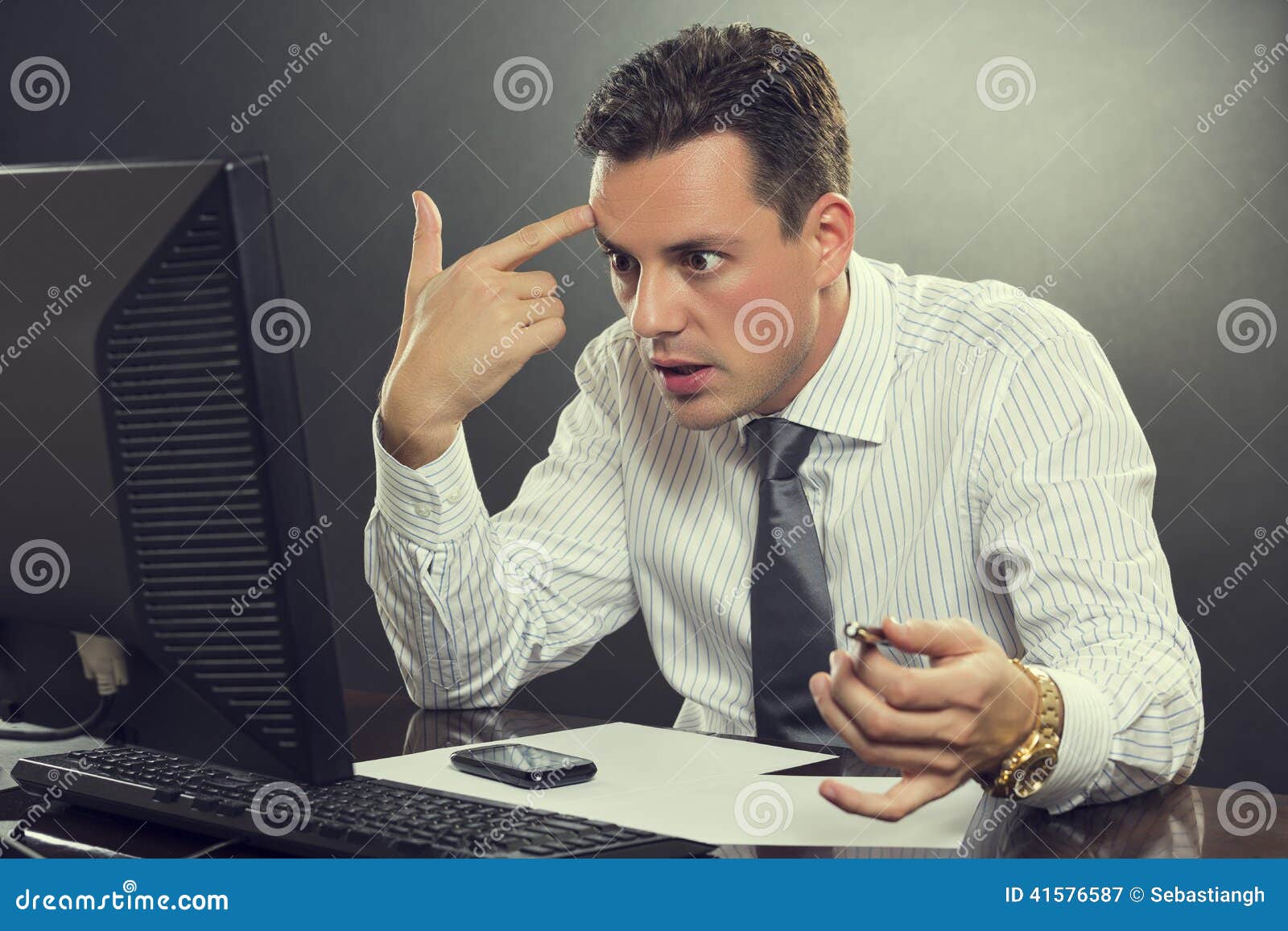 Surreptitious Gesture With The Head Desperate Businessman Pointing His Finger To His Head Stock Photo