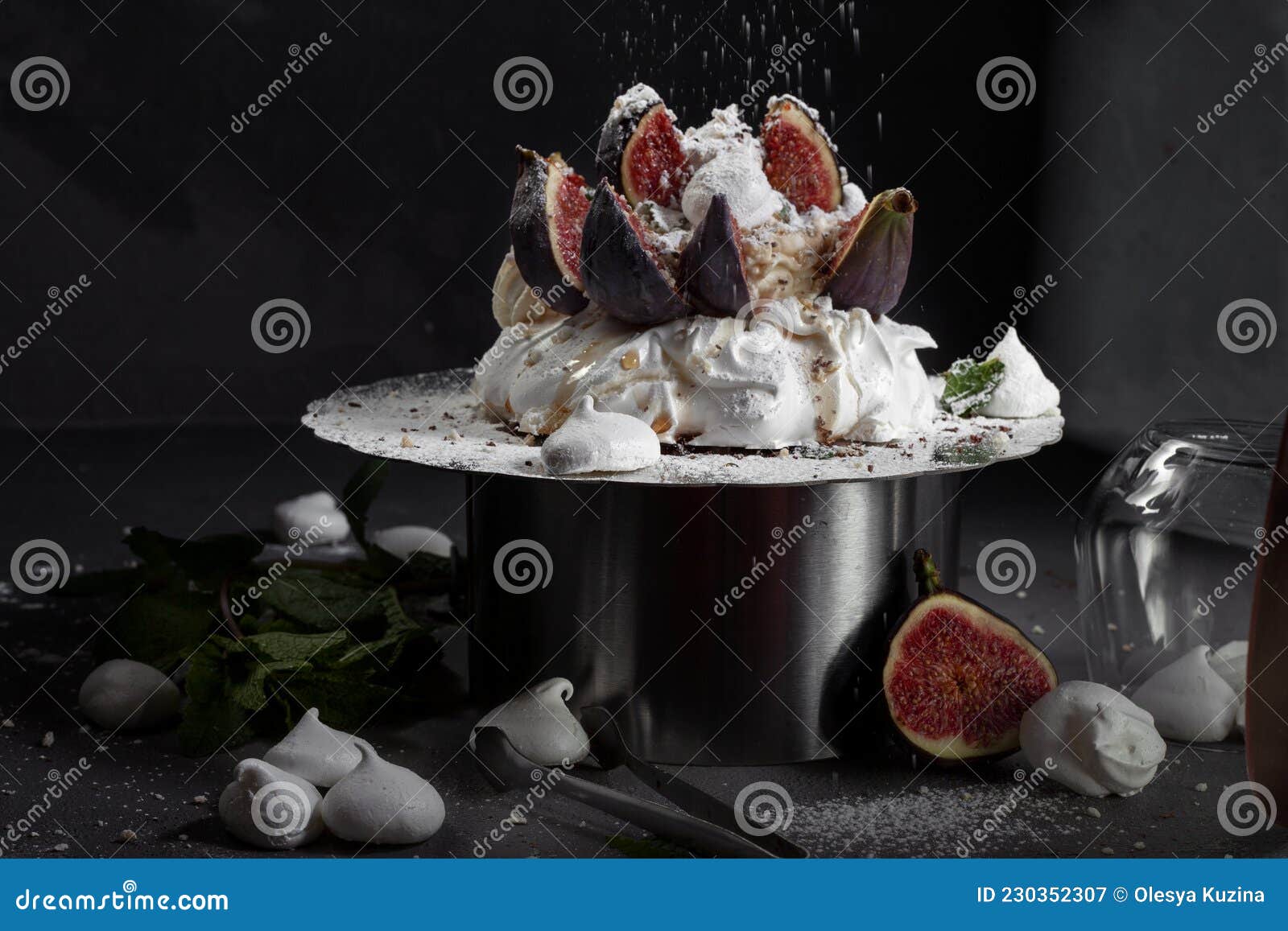 dessert on a black background. anna pavlova`s meringue with whipped cream and fresh figs