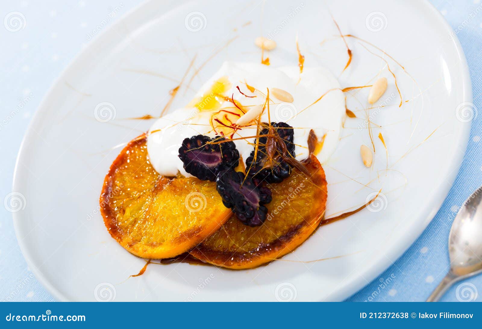 dessert with caramelized oranges, yogurt, brambleberries