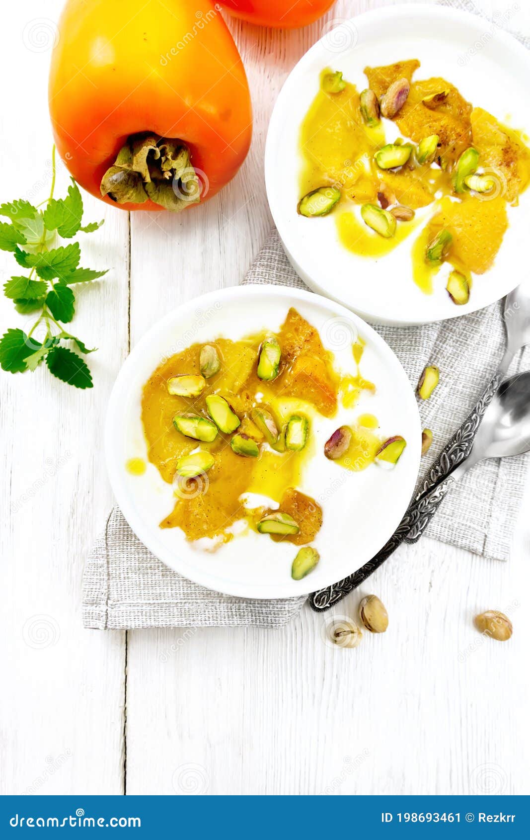 Dessert of Yogurt and Persimmon Two Bowls on Board Top Stock Image ...