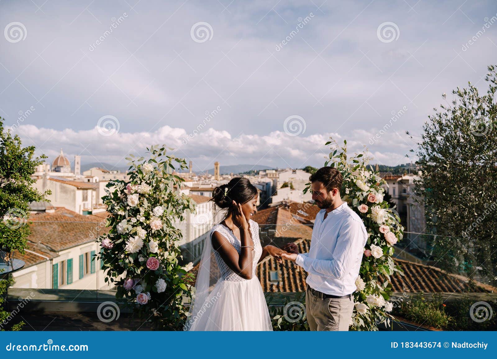 destination fine-art wedding in florence, italy. multiracial wedding couple. a wedding ceremony on the roof of the