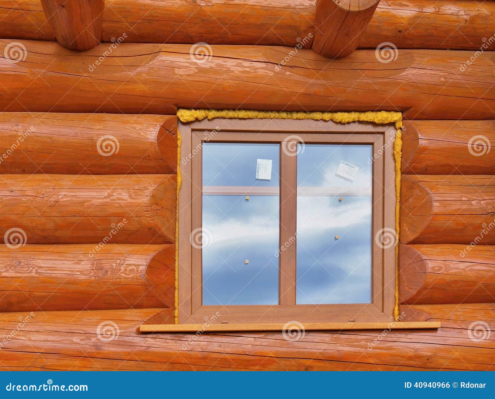detail of beams in cabin wall. painted wood with fungicide paint and wooden window