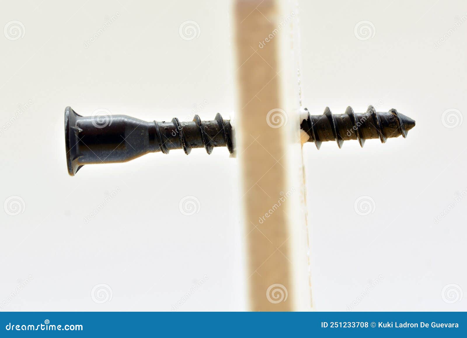 detail of a screw going through a wall