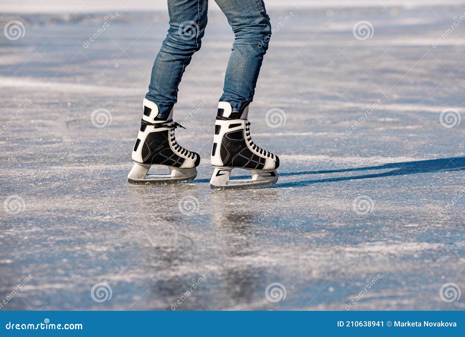 Detail of the Black and White Mens Ice Skates in Action on Ice