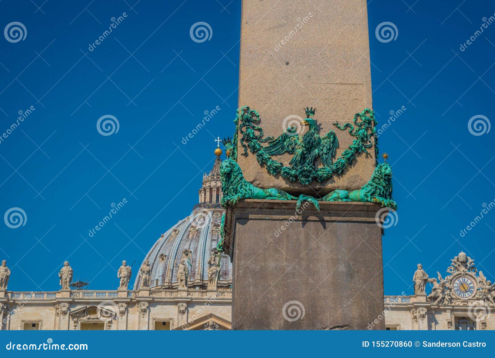 detail of bronze lions holding the egyptian obelisk and the basilica of st. peter in the background in the vatican