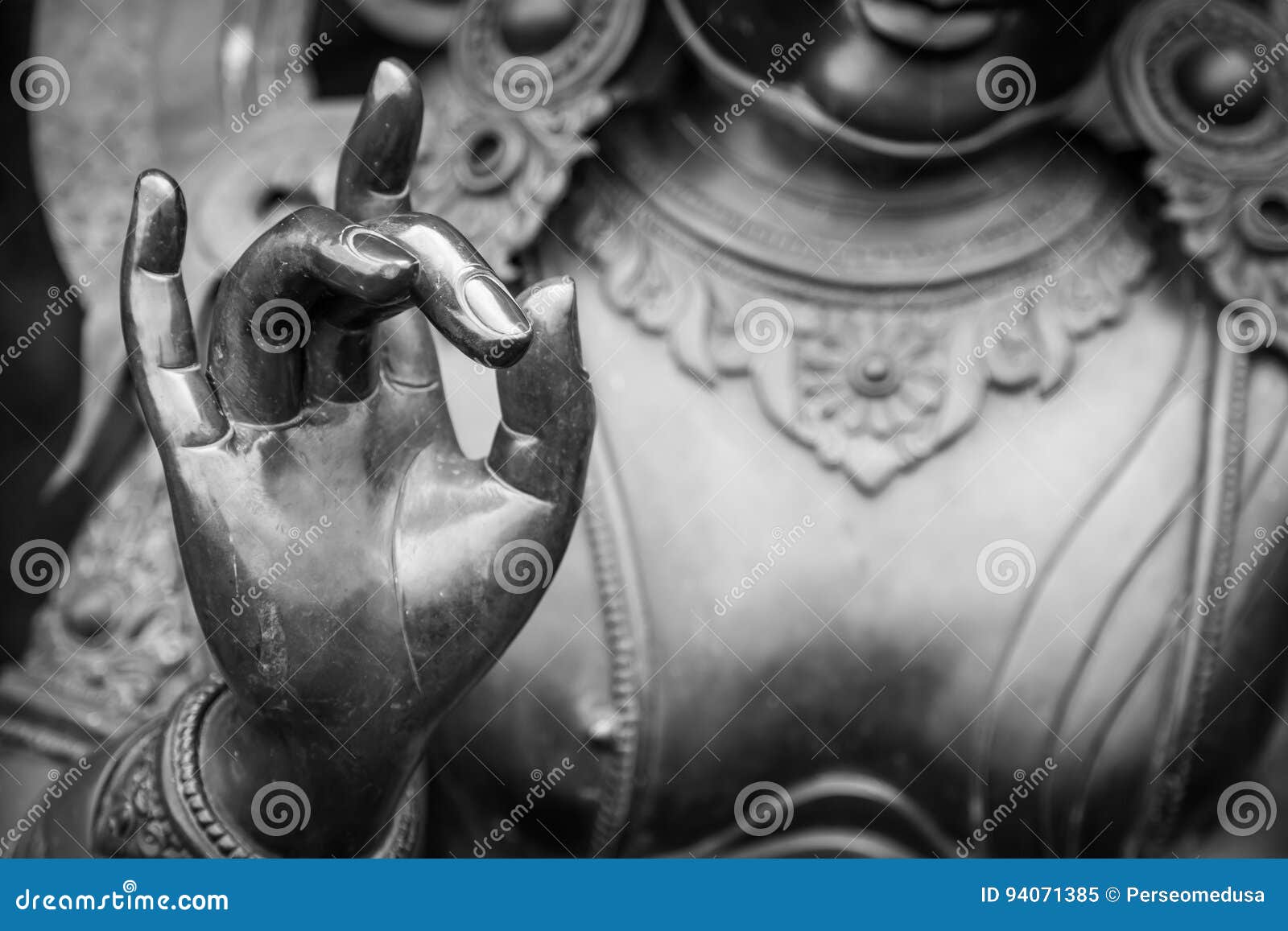detail of buddha statue with karana mudra hand position