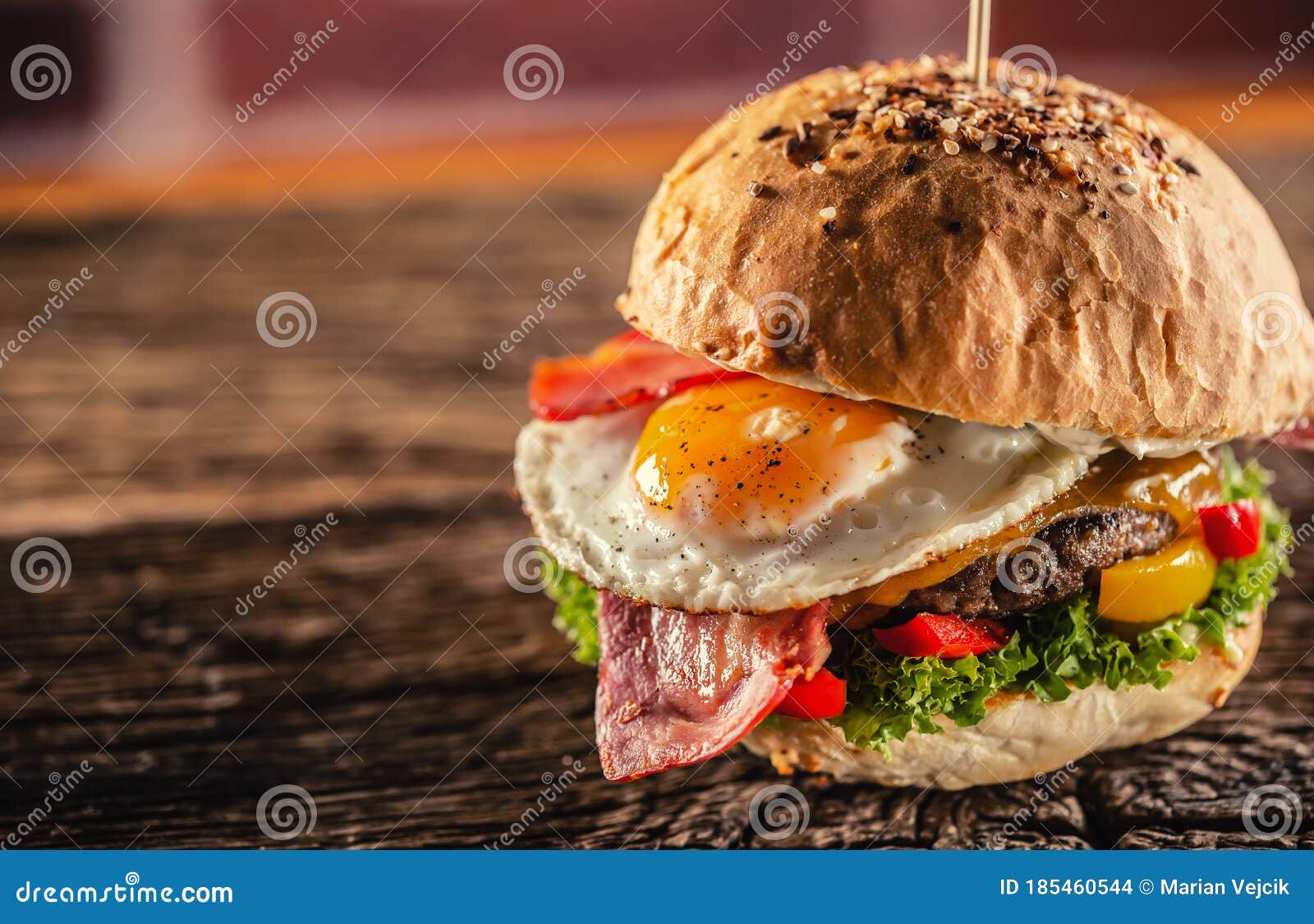 Detail of a Burger with Beef, Cheese, Egg, Bacon, Salad, Peppers in a ...