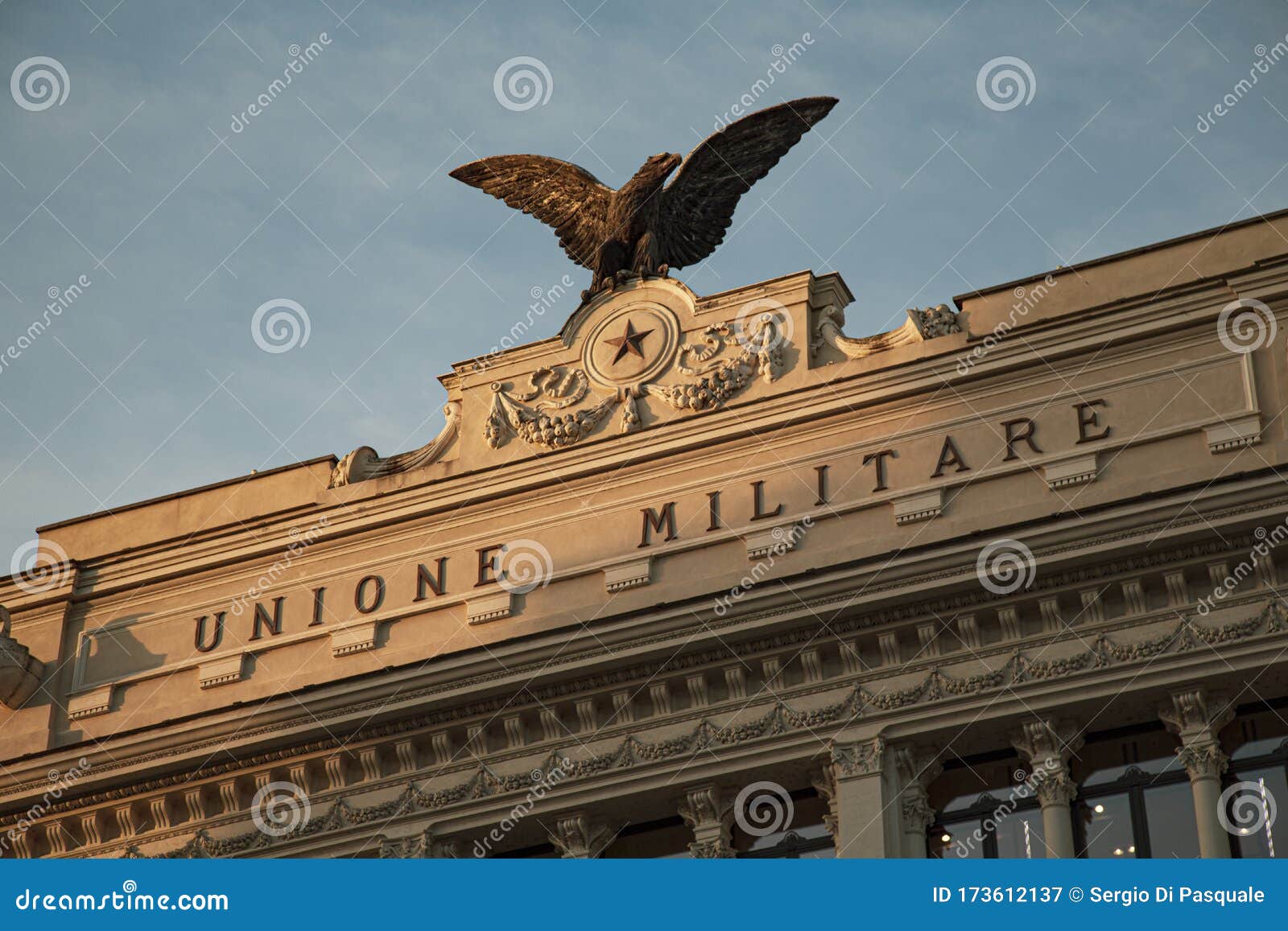 detail of the effigy with eagle located on the facade of the palace of the former military union palazzo dell`ex unione militare