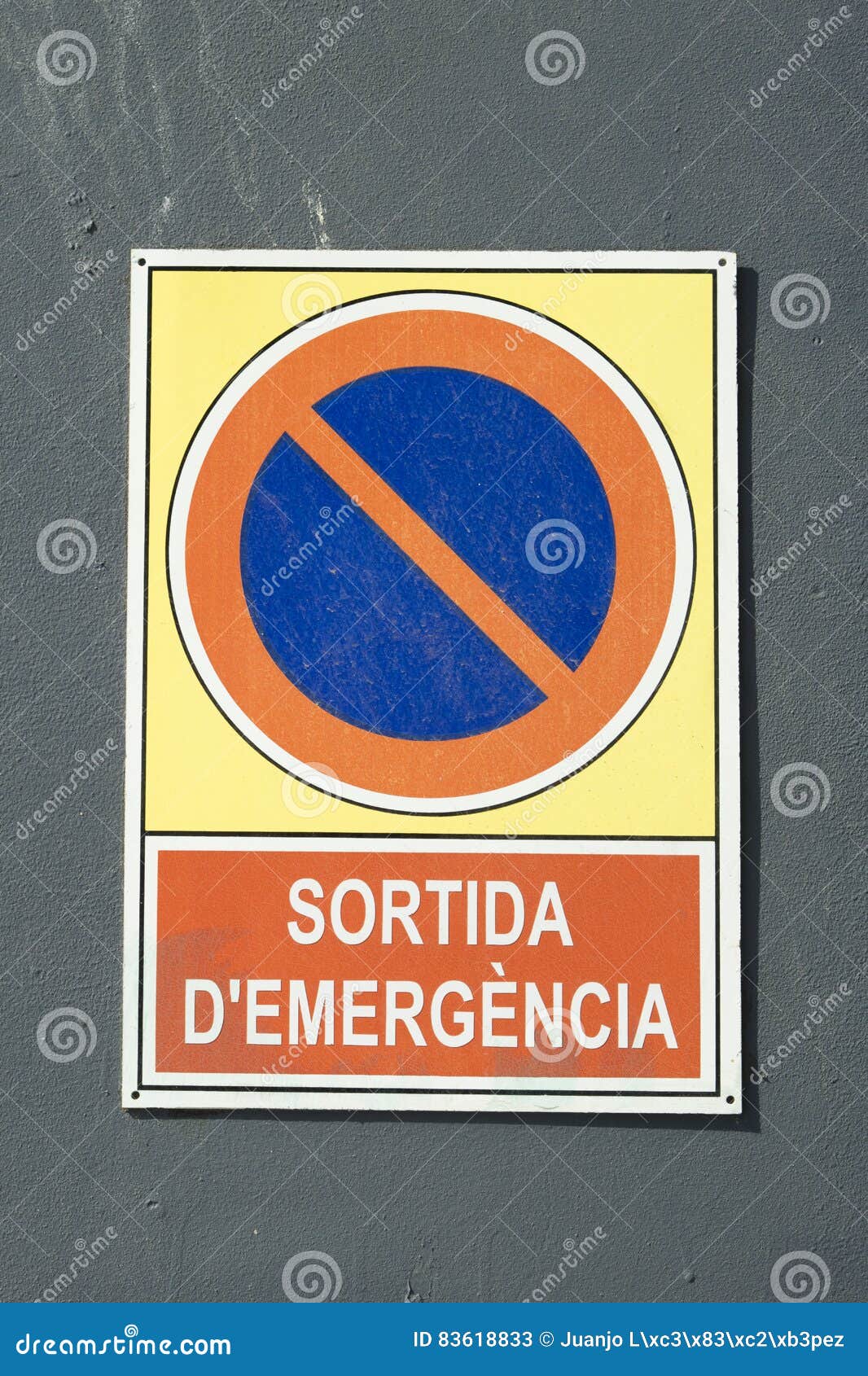 detail of emergency exit sign board, written in catalan: