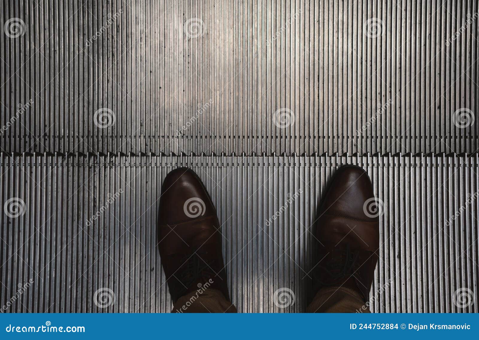 A man on the escalator stock photo. Image of shoelace - 244752884