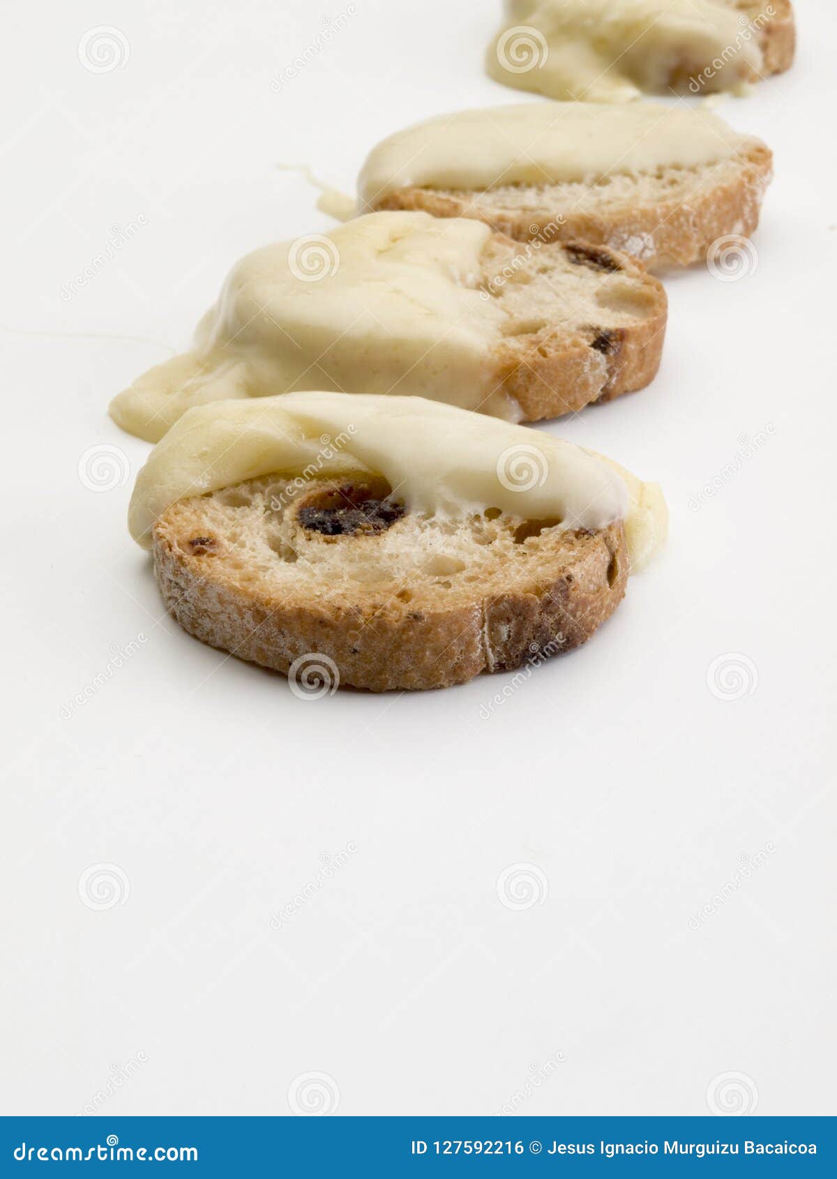 detail of four bread toast with raisins and melted cheese
