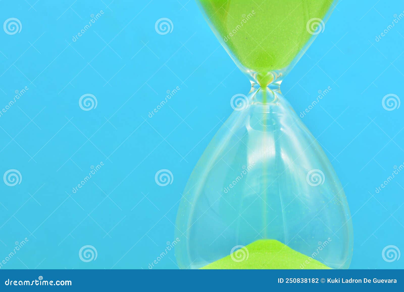 detail of a green hourglass telling the time