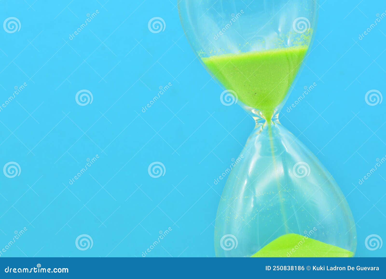 detail of a green hourglass telling the time