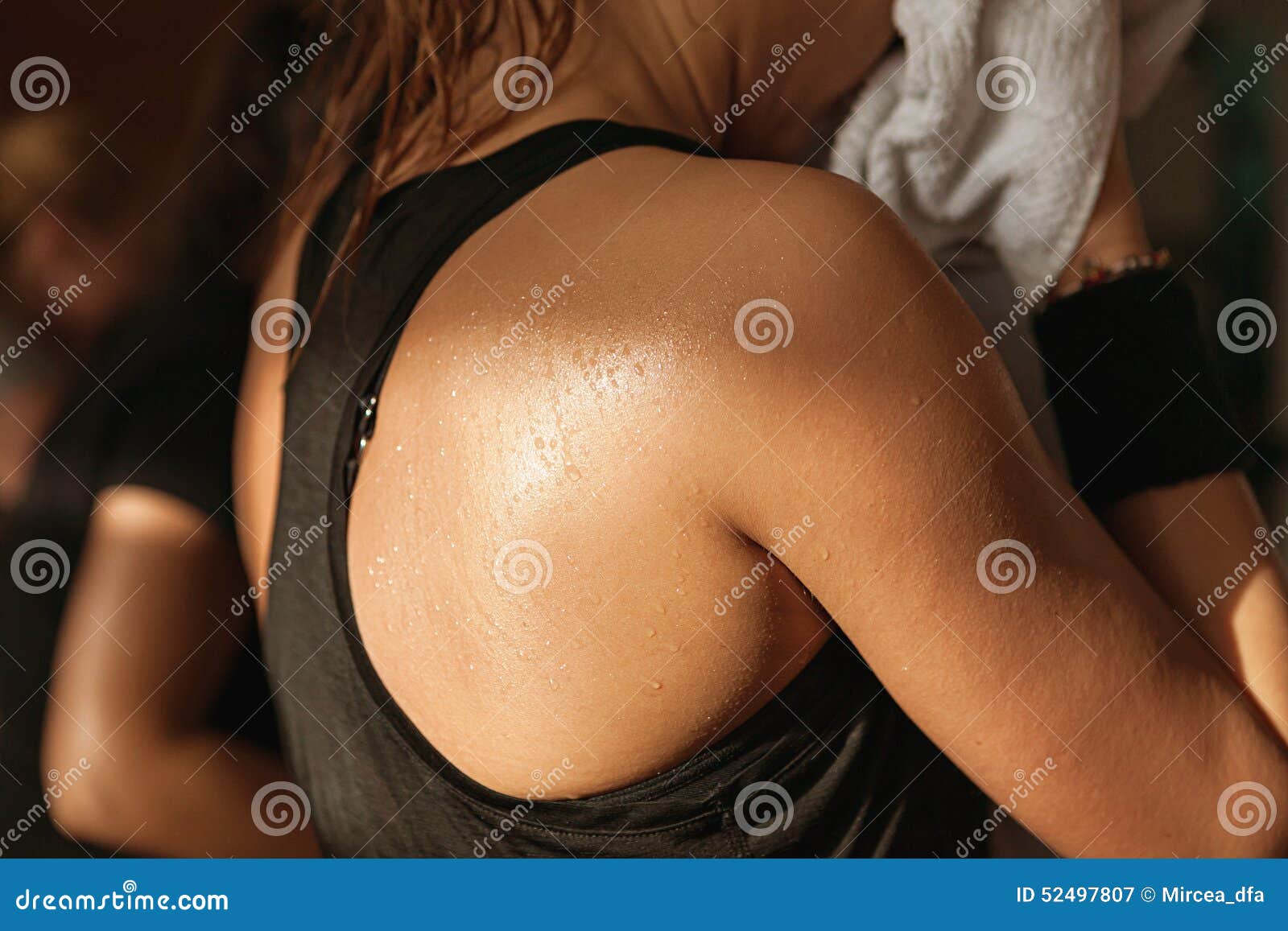 detail gym shot - sweat skin of a woman's back; spinning, aerobi