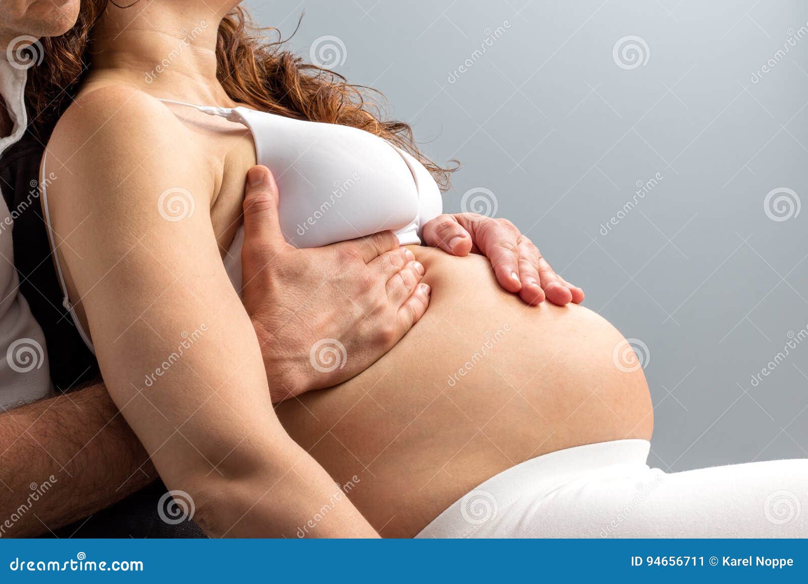 Detail of Hands Massaging Pregnant Belly