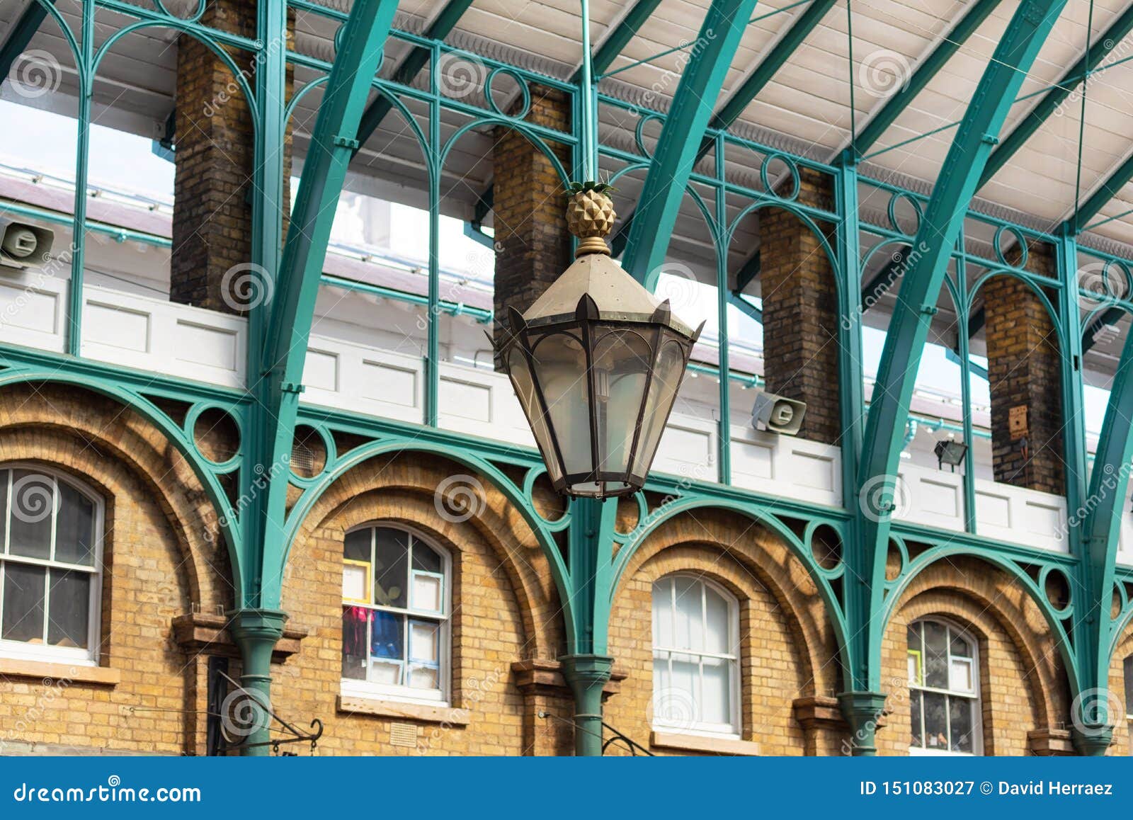 detail of a lamp hanging from the steel roof of covent garden market in london united kingdom.