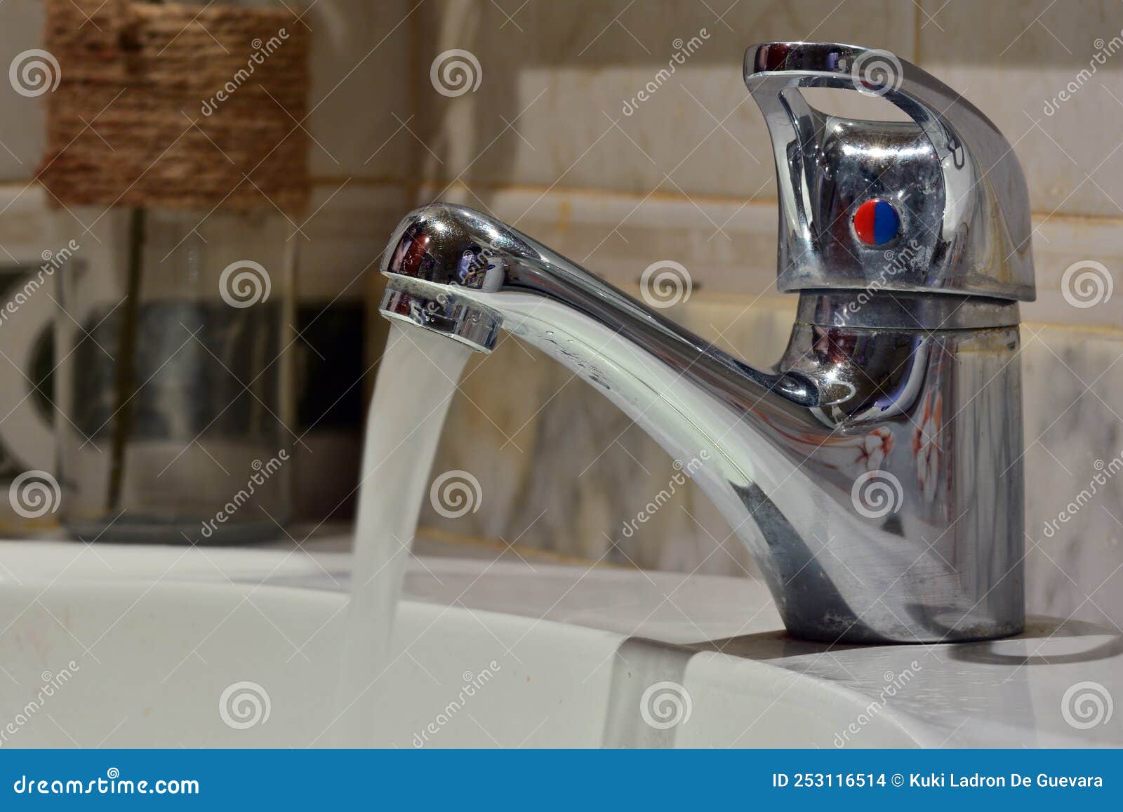 stream of water falling from a faucet in a sink