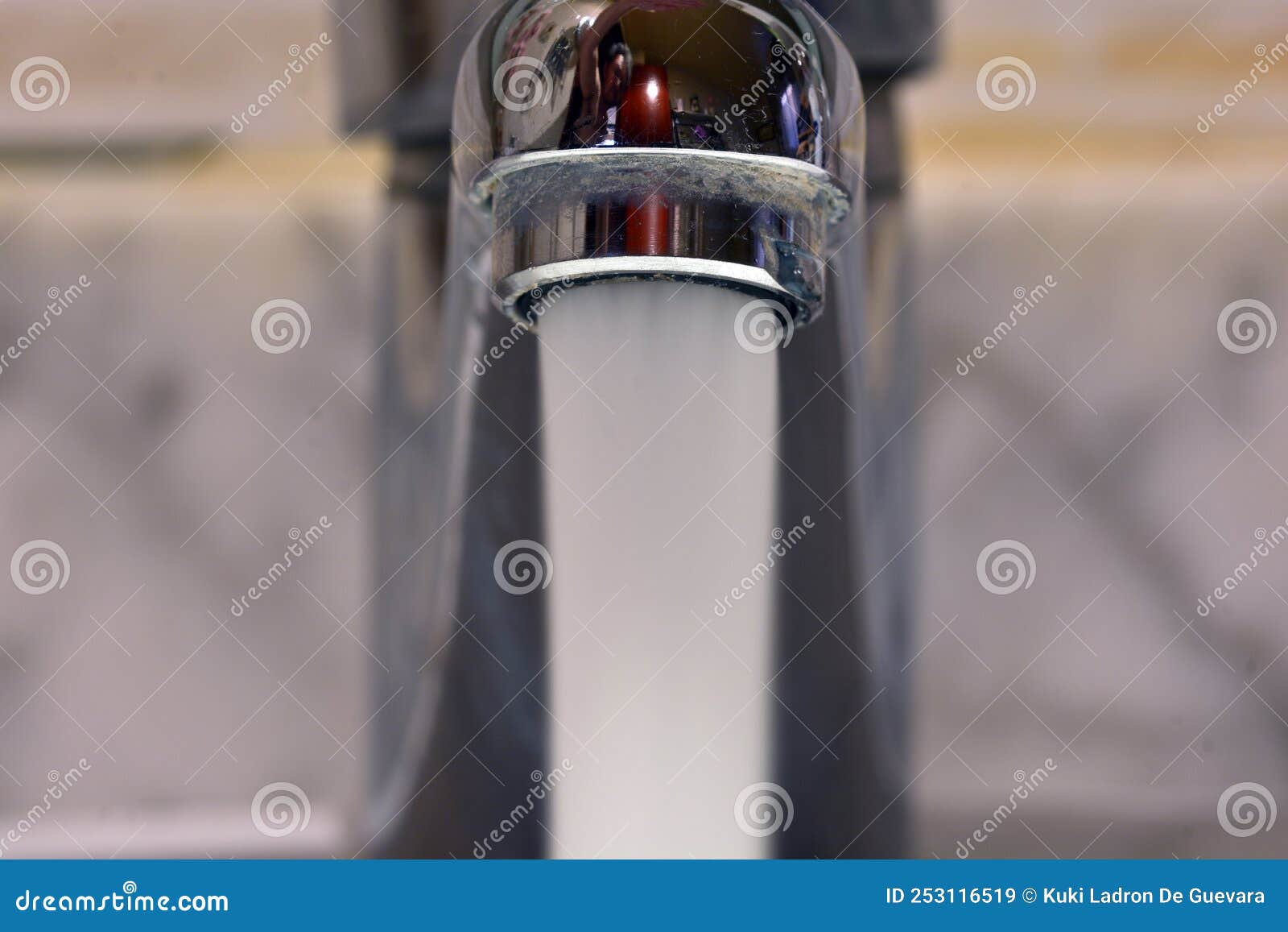 stream of water falling from a faucet in a sink