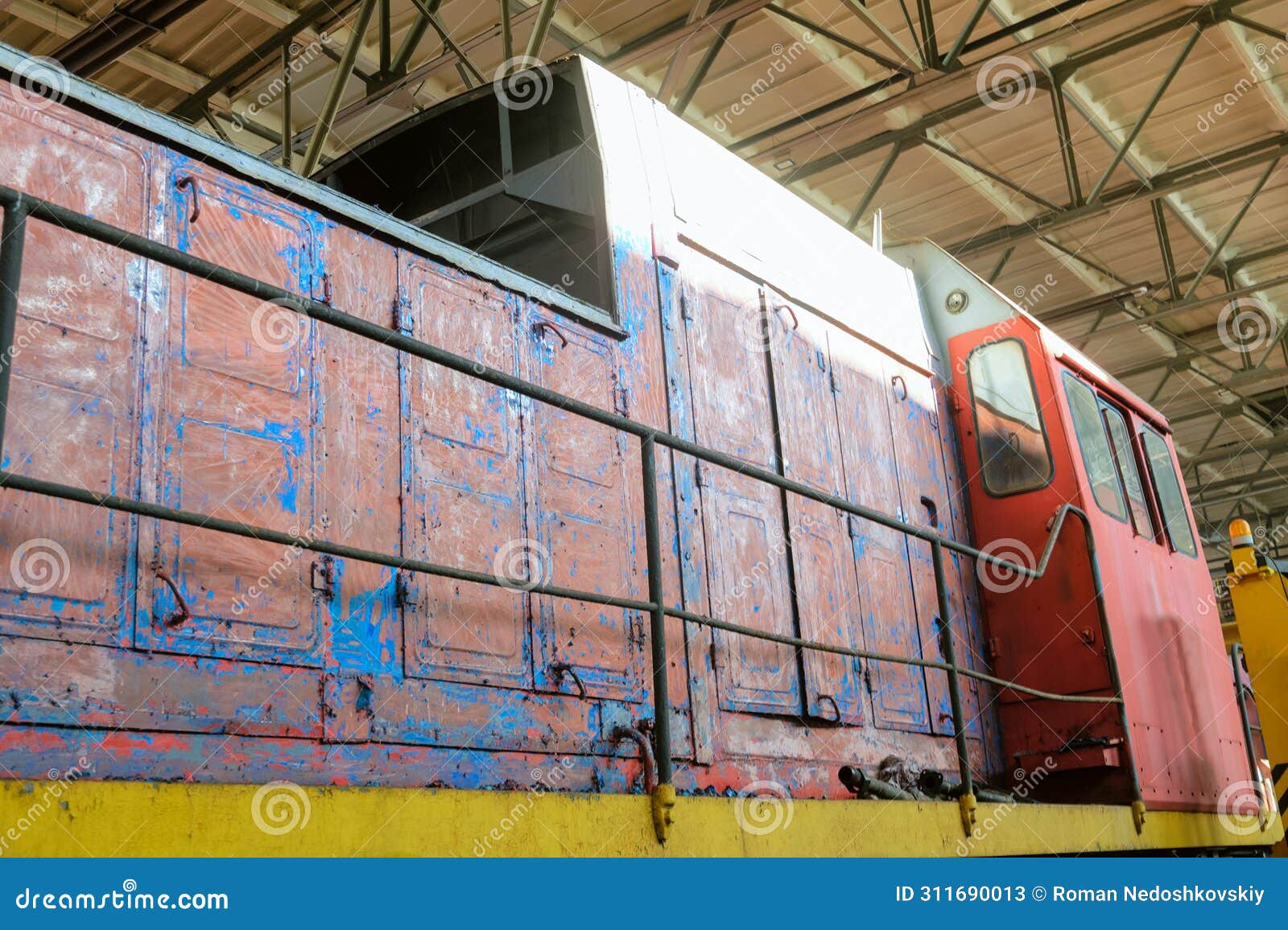 detail of old traction locomotive on serviced at a repair depot