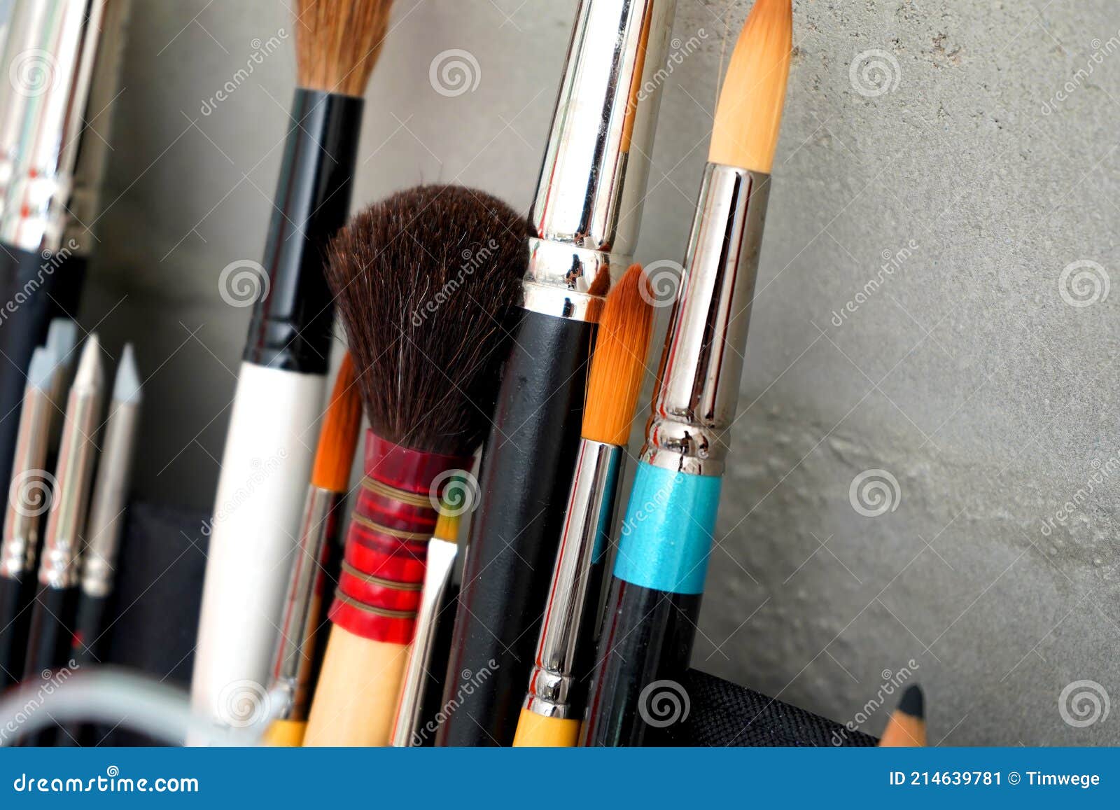 detail of paint brushes and bright paint in artistÃ¢â¬â¢s studio