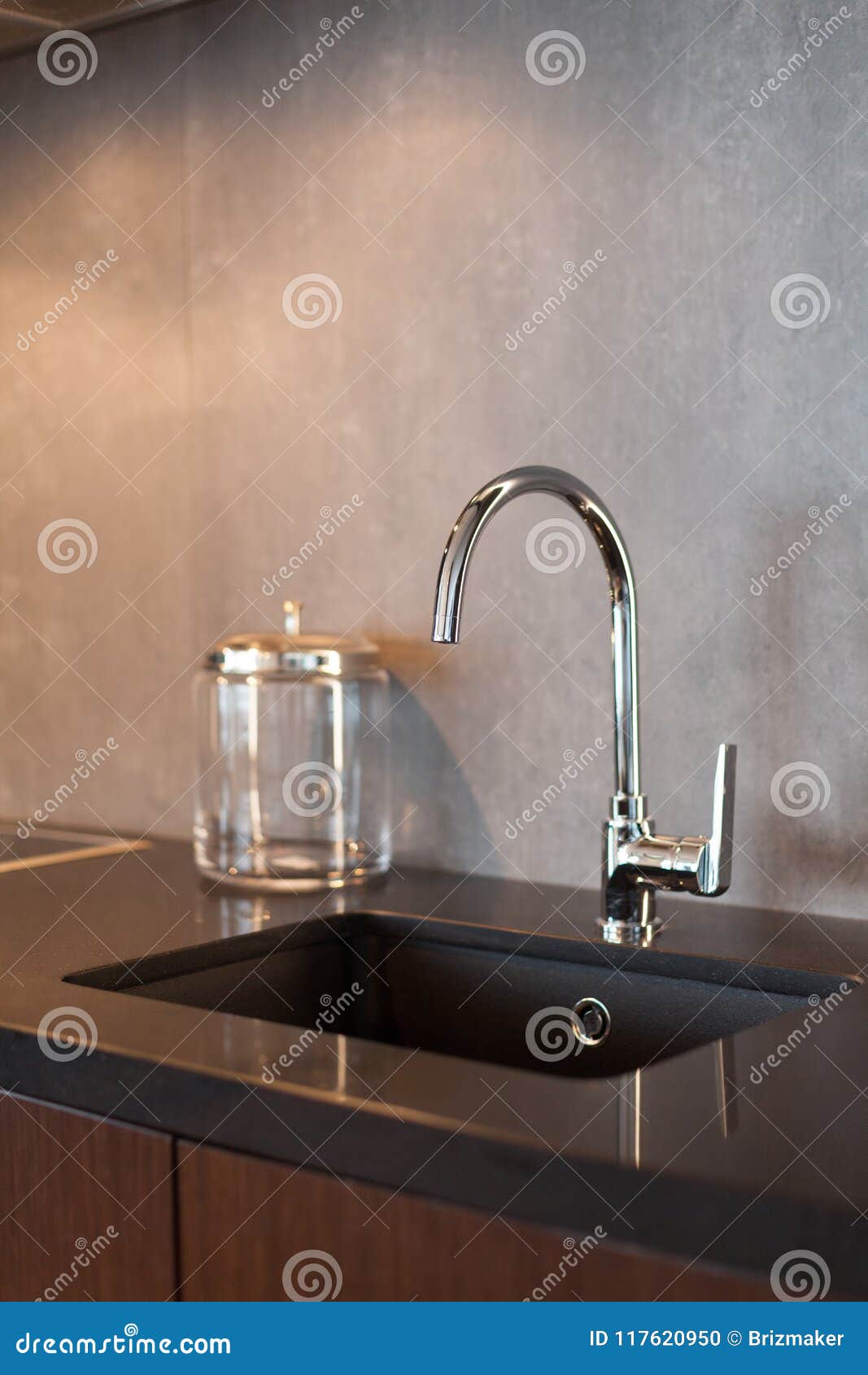 Detail of a Rectangular Designer Kitchen Sink with Chrome Water Tap