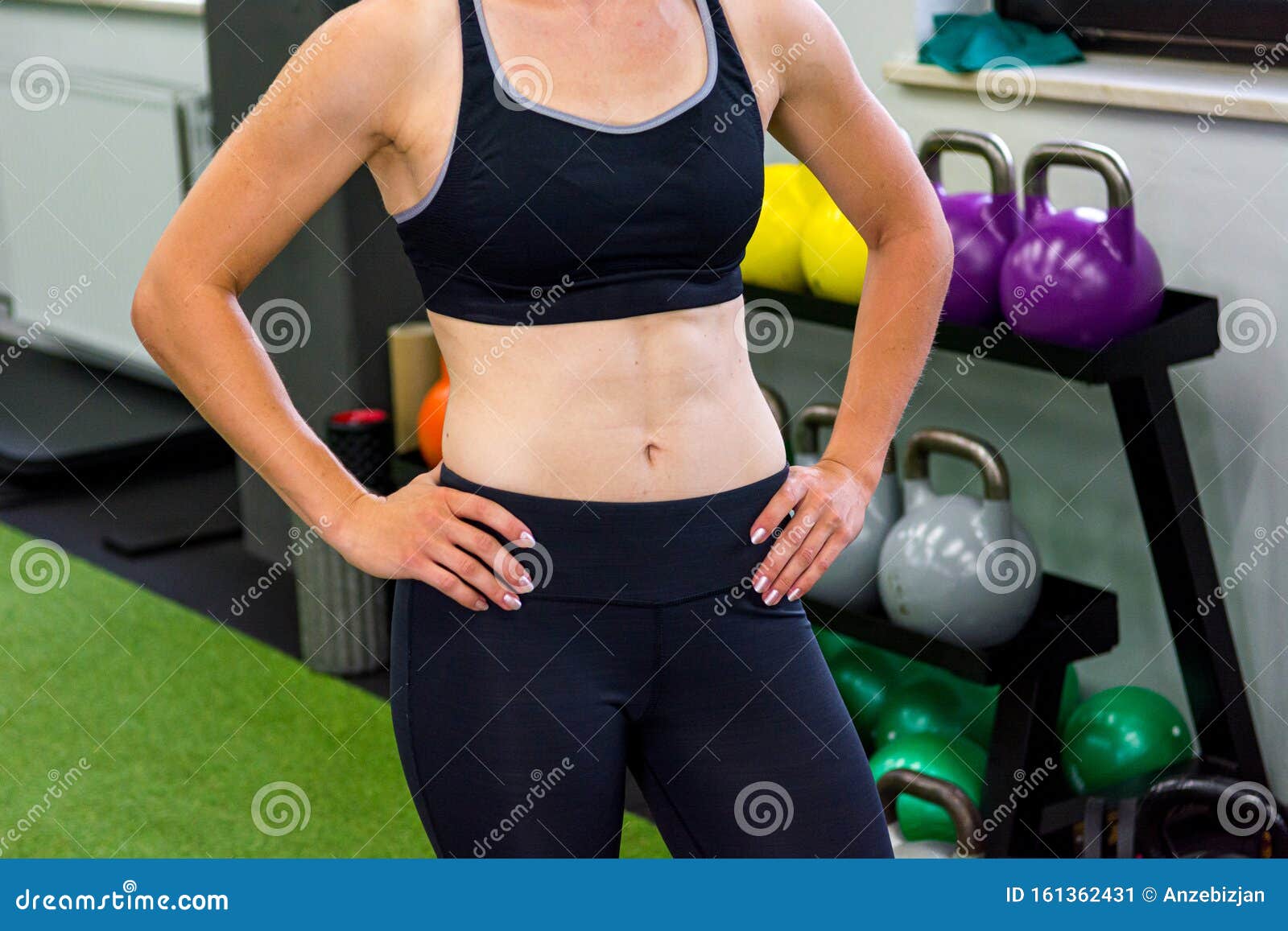 Detail Shot Of Female Trainer Posing In Local Gym Shoving Her