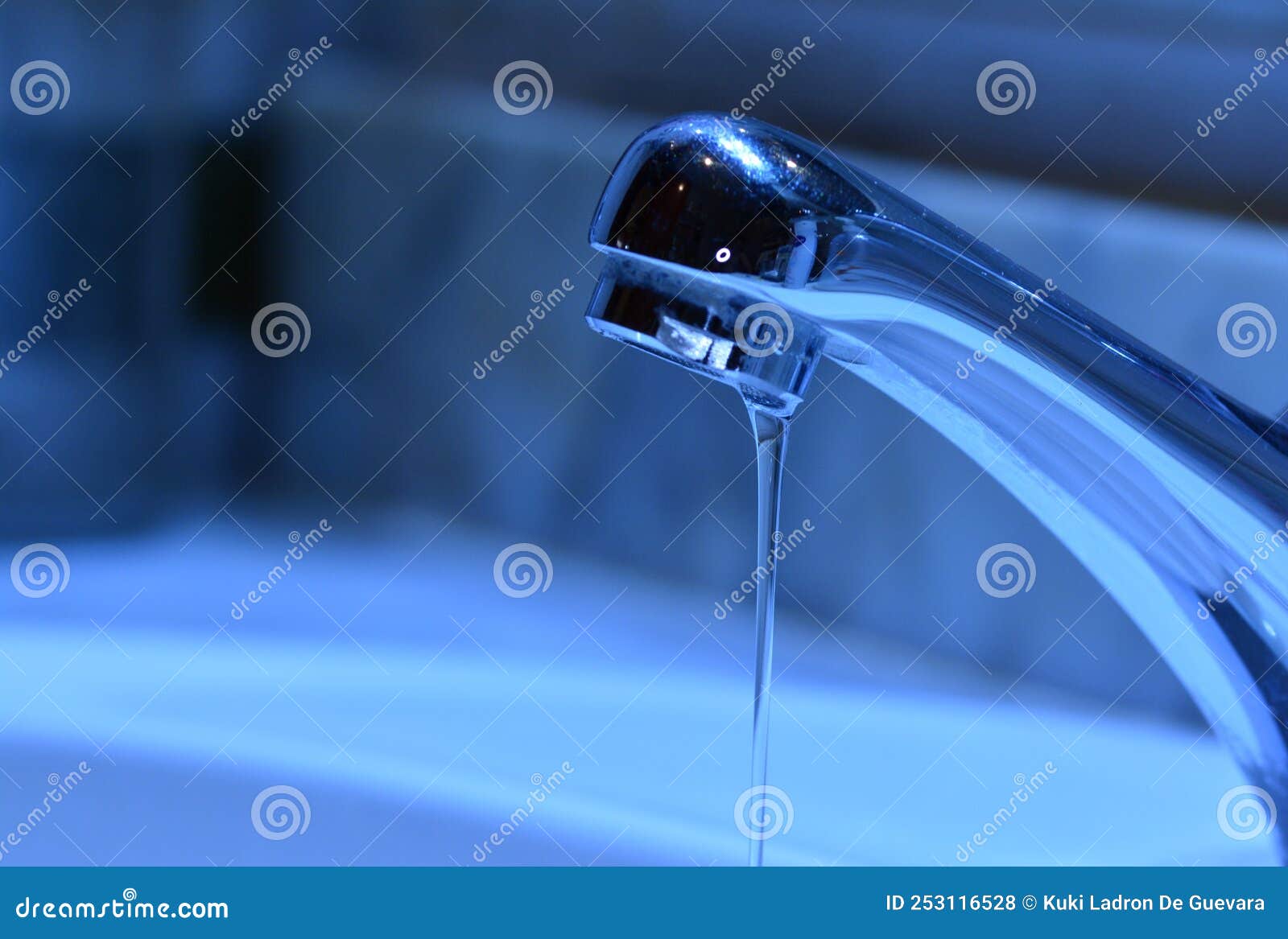 small stream of water falling from a sink faucet