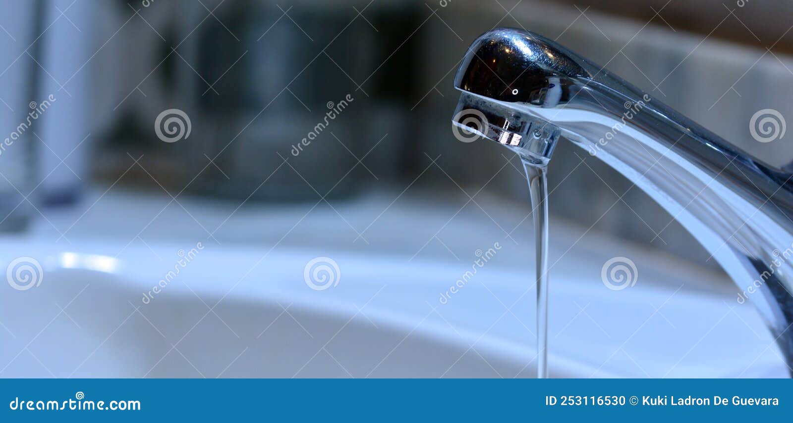 small stream of water falling from a sink faucet