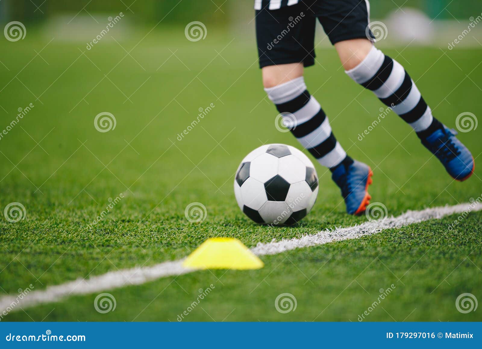 detail soccer player kicking ball on pitch sideline. soccer player on a game